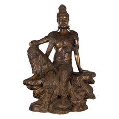 Vintage Bronze Statuette Depicting Quan Yin Seated on a Rocky Formation