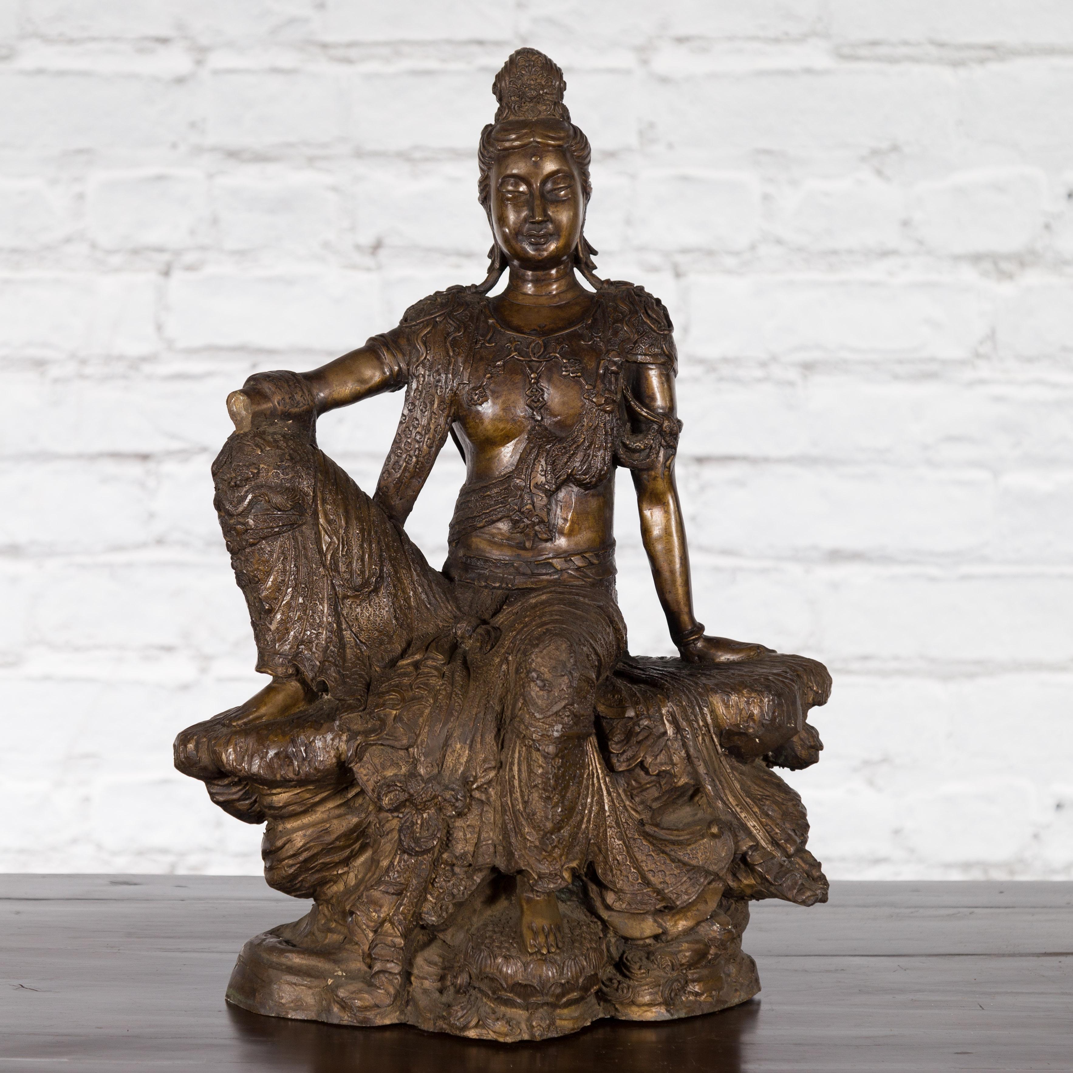 Vintage Bronze Statuette Depicting Quan Yin Seated on a Rocky Formation In Good Condition For Sale In Yonkers, NY