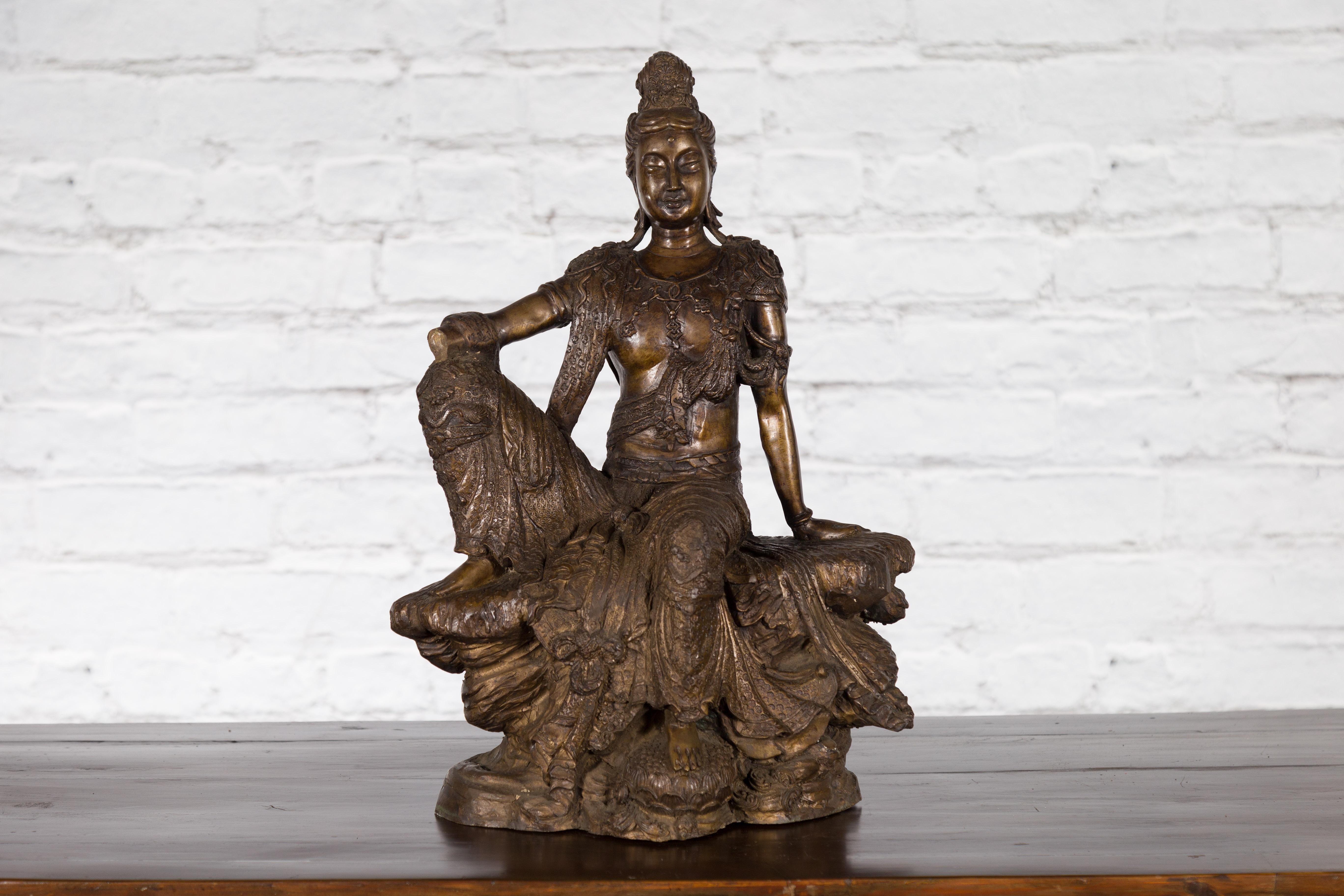 20th Century Vintage Bronze Statuette Depicting Quan Yin Seated on a Rocky Formation For Sale