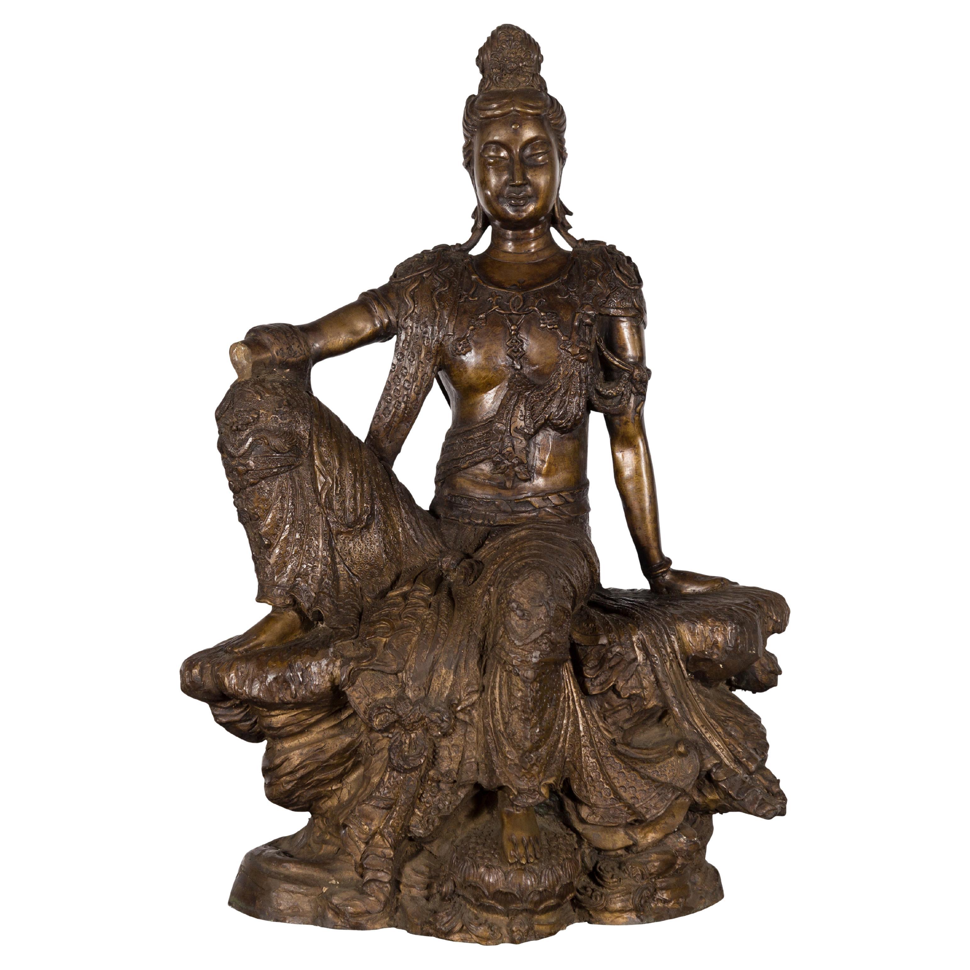 Vintage Bronze Statuette Depicting Quan Yin Seated on a Rocky Formation For Sale