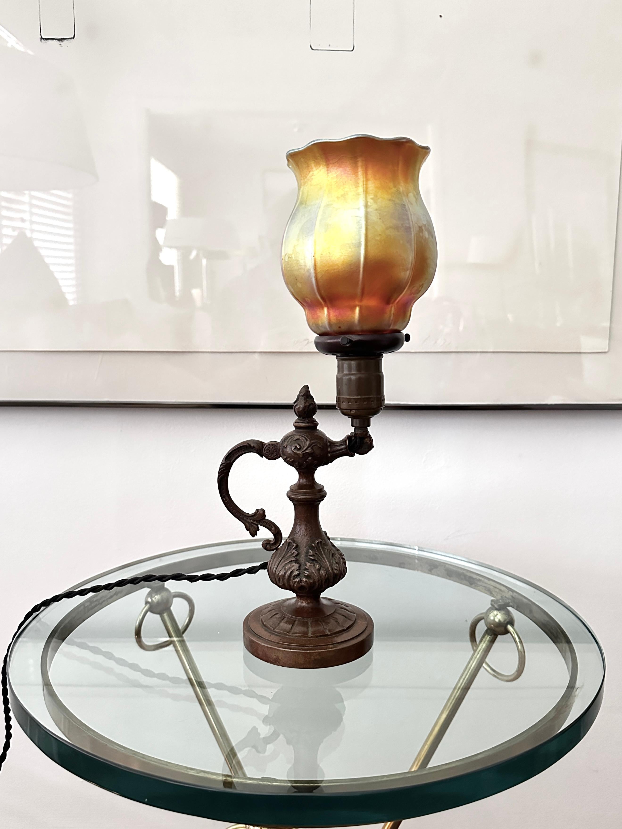 A heavy solid bronze high quality table lamp or wall lamp. No markings on the lamp, but probably American dating from the first quarter of the 20th century. The lamp and socket have its original patina. The socket, insulator, twisted cord, globe