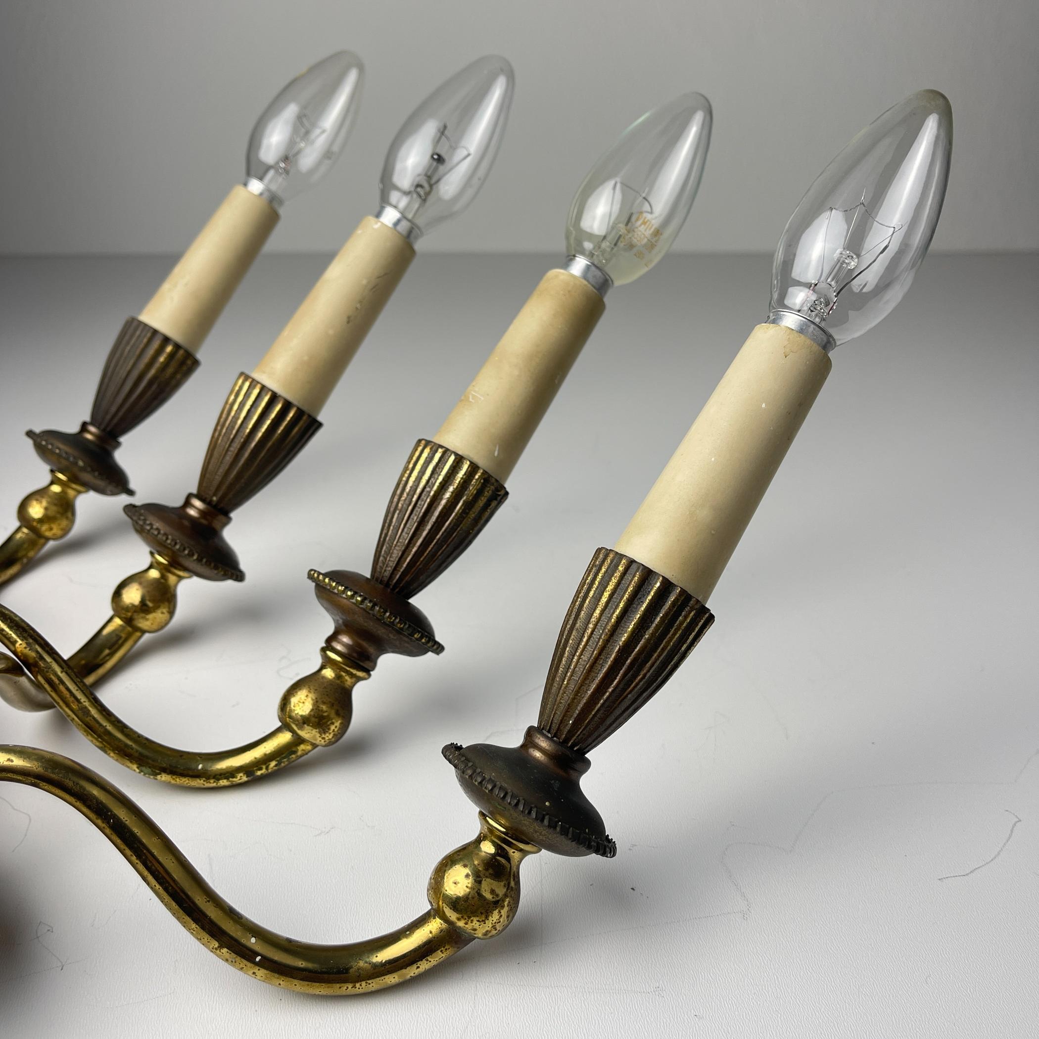 

Amazing pair of vintage bronze wall lamps made in Italy in the 1950s.

The lamp is in good vintage condition.

Dimensions:
Width: 23 cm / 9 inches
Height: 30 cm / 11.8 inches
Depth: 13 cm / 5.11 inches

Lamp requires European 2 x E14 lightbulb and