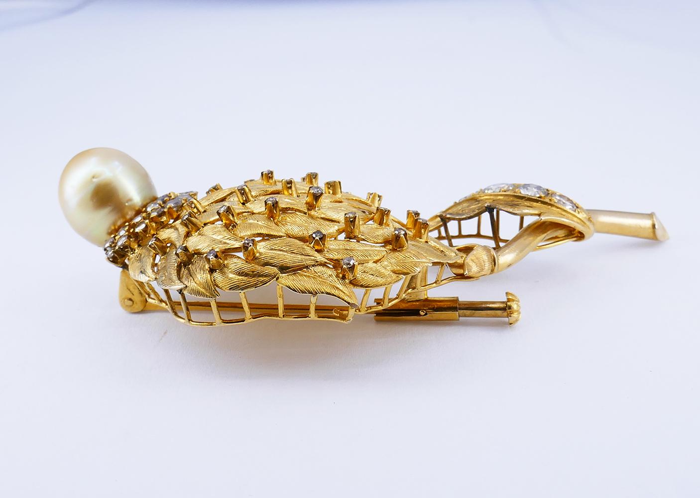 	A spectacular vintage brooch pin made of 14 karat gold, featuring a pearl and diamonds.
	Being a unique estate jewelry piece, this vintage gold pin is designed as an artichoke thistle flower. The “petals” were meticulously crafted by using
