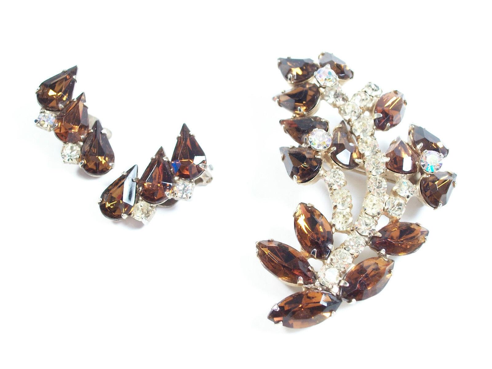 Vintage brooch and earrings demi parure - set with faux topaz and rhinestones - clip on backs to earrings - unsigned - circa 1950's.

Excellent vintage condition - minor signs of wear - one side of the brooch pin/closure is detached and may need