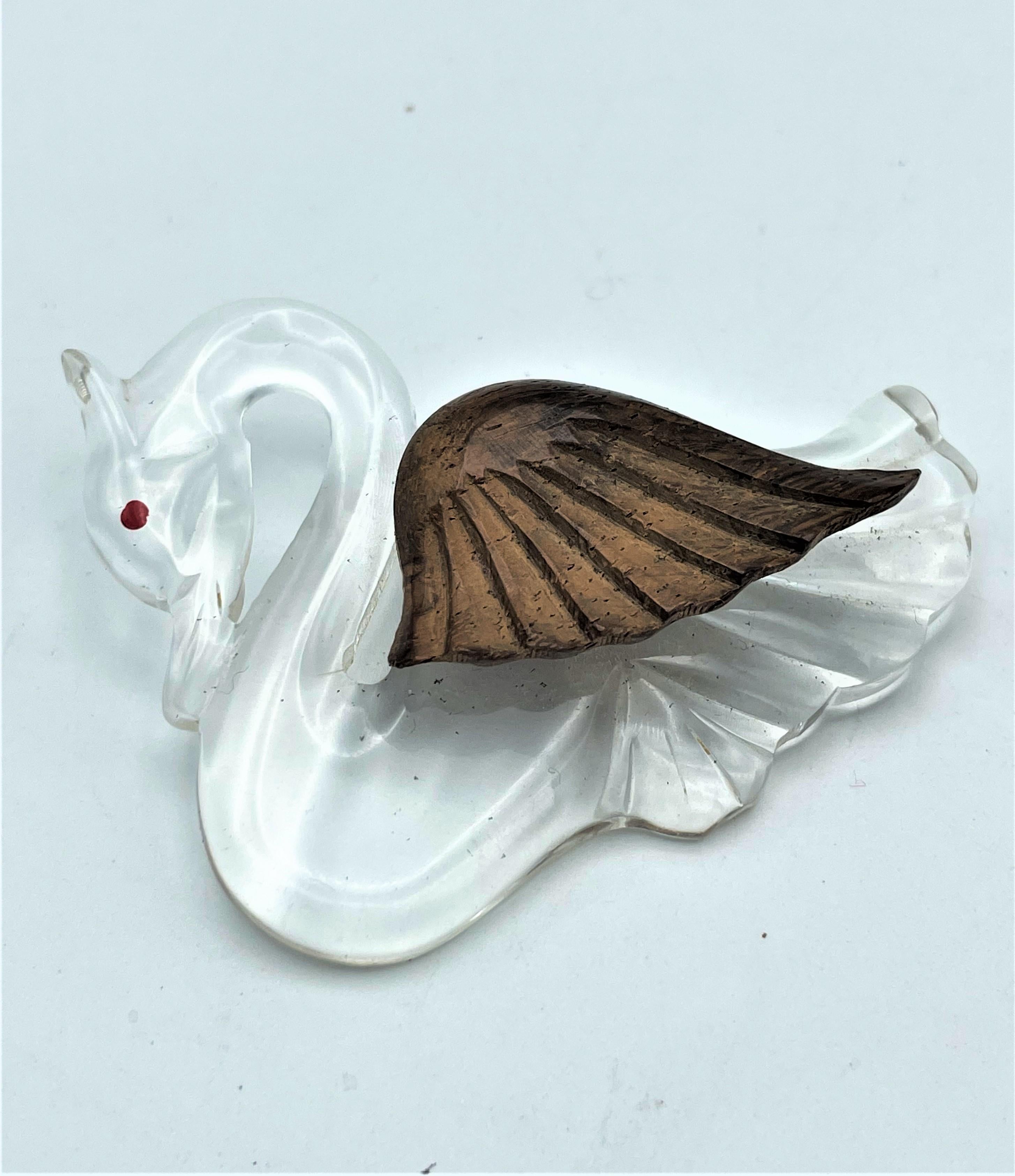Modern Vintage brooch in the shape of a swan made of clear Lucite and wooden wings 1940 For Sale