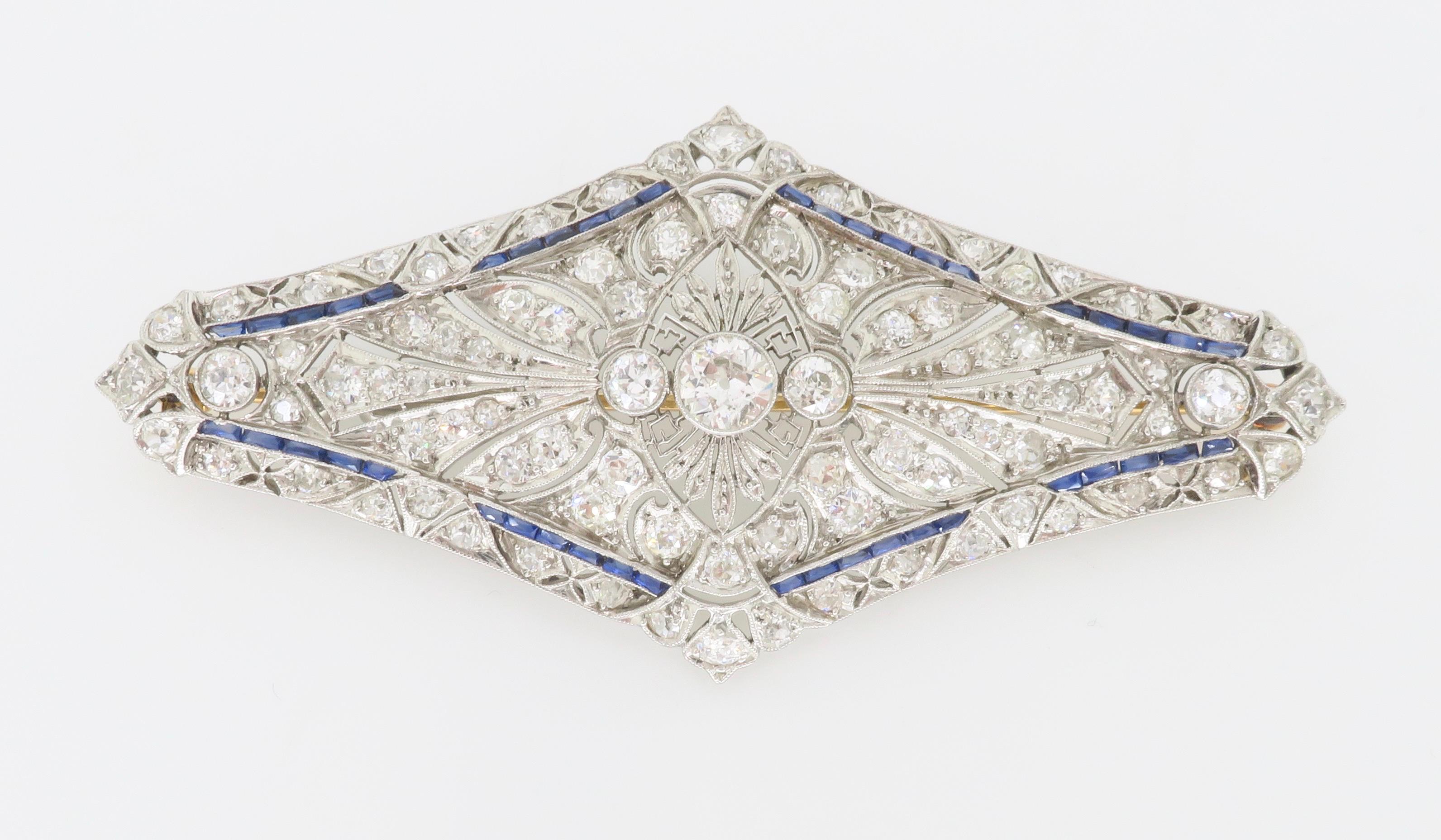 Vintage Diamond & Blue Sapphire brooch made in intricate Platinum with an 18k yellow gold pin. 

Diamond Carat Weight: Approximately 4.88CTW
Diamond Cut: Old European Cut Diamonds 
Color: Average E-F
Clarity: Average VS
Metal: Platinum & 18k Yellow