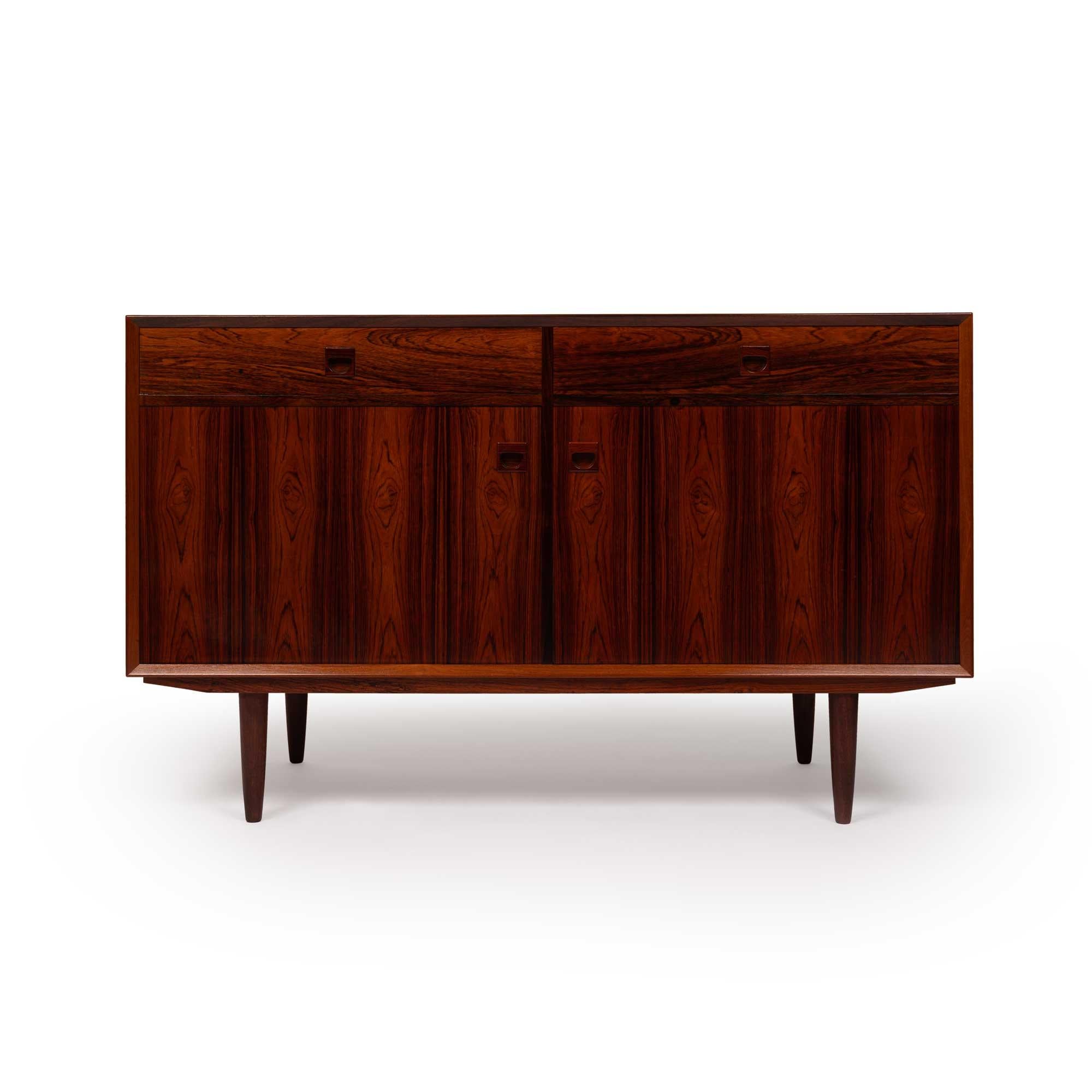 Brouer Møbelfabrik, a renowned Danish furniture maker of the mid-20th century, crafted timeless designs with exceptional craftsmanship. Specializing in fine woods like teak and rosewood, their sleek, minimalist pieces are highly sought after by