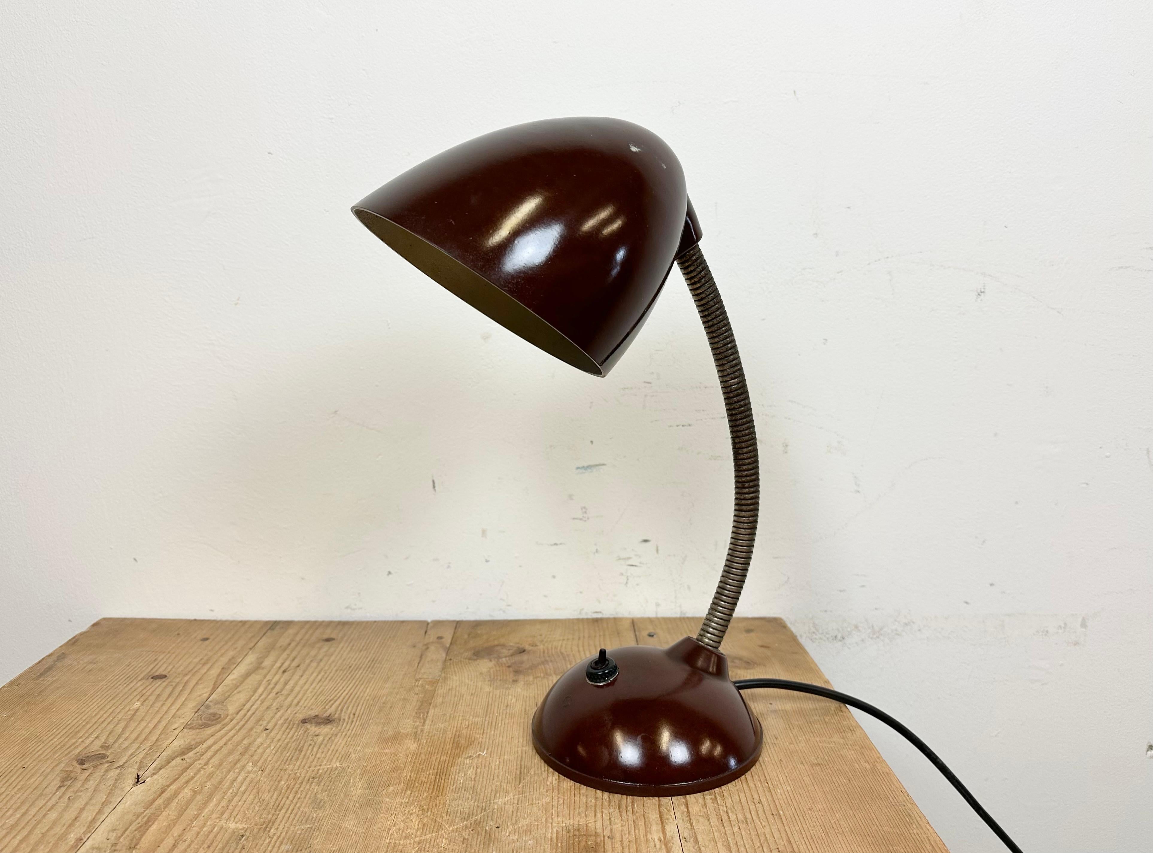 Brown industrial table lamp made by Elektroinstala Děčín in former Czechoslovakia during the 1960s. It features a bakelite shade and base and iron gooseneck.The original socket requires E 27 light bulbs. Original switch. New wire. Good vintage