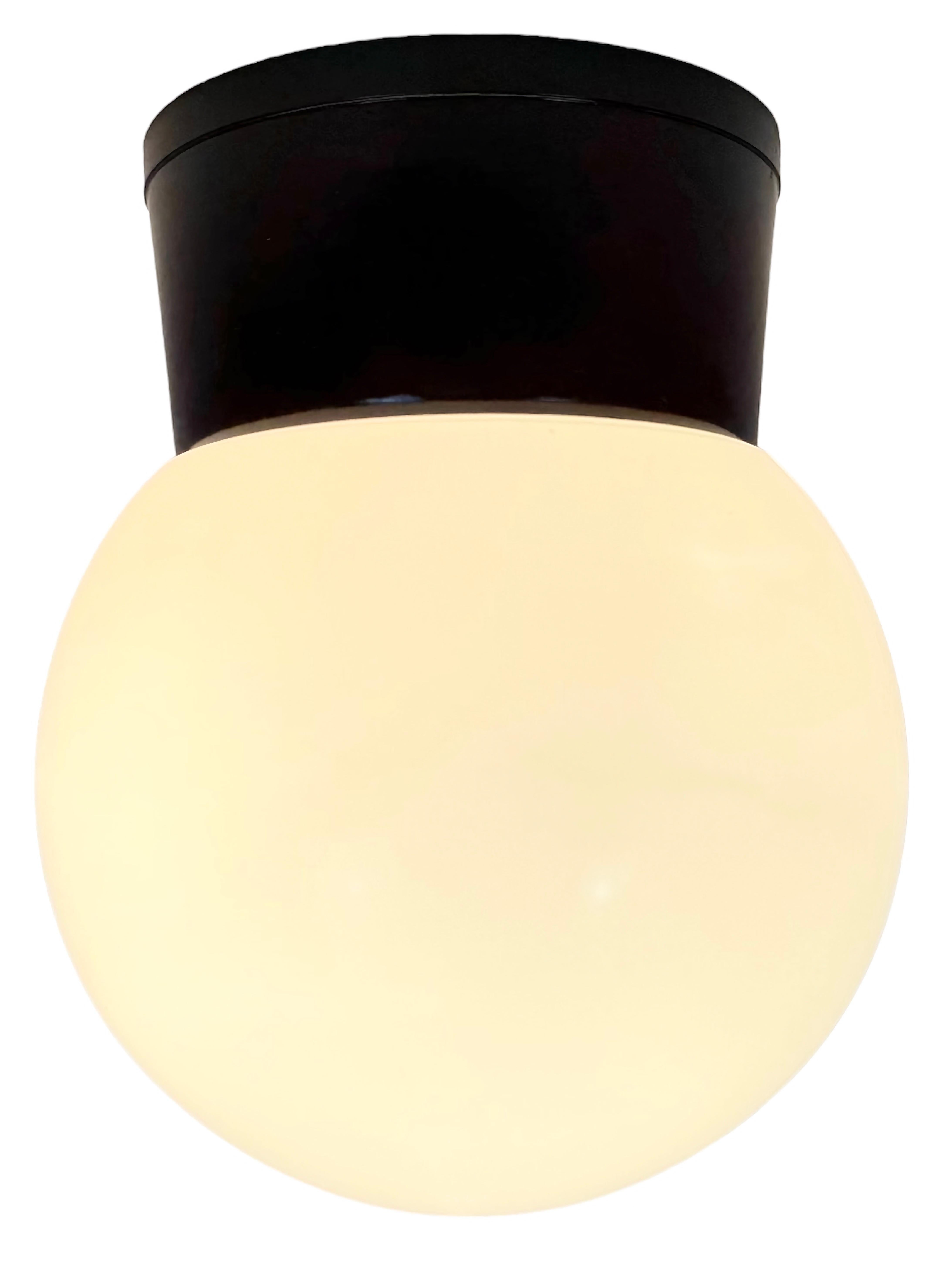 Vintage industrial brown bakelite lamp made in former Czechoslovakia during the 1960s. It features a bakelite wall or ceiling mounting and a milk glass cover .The socket requires standard E 27/E 26 light bulbs.  Weight of the lamp is 0,5kg.
Diameter