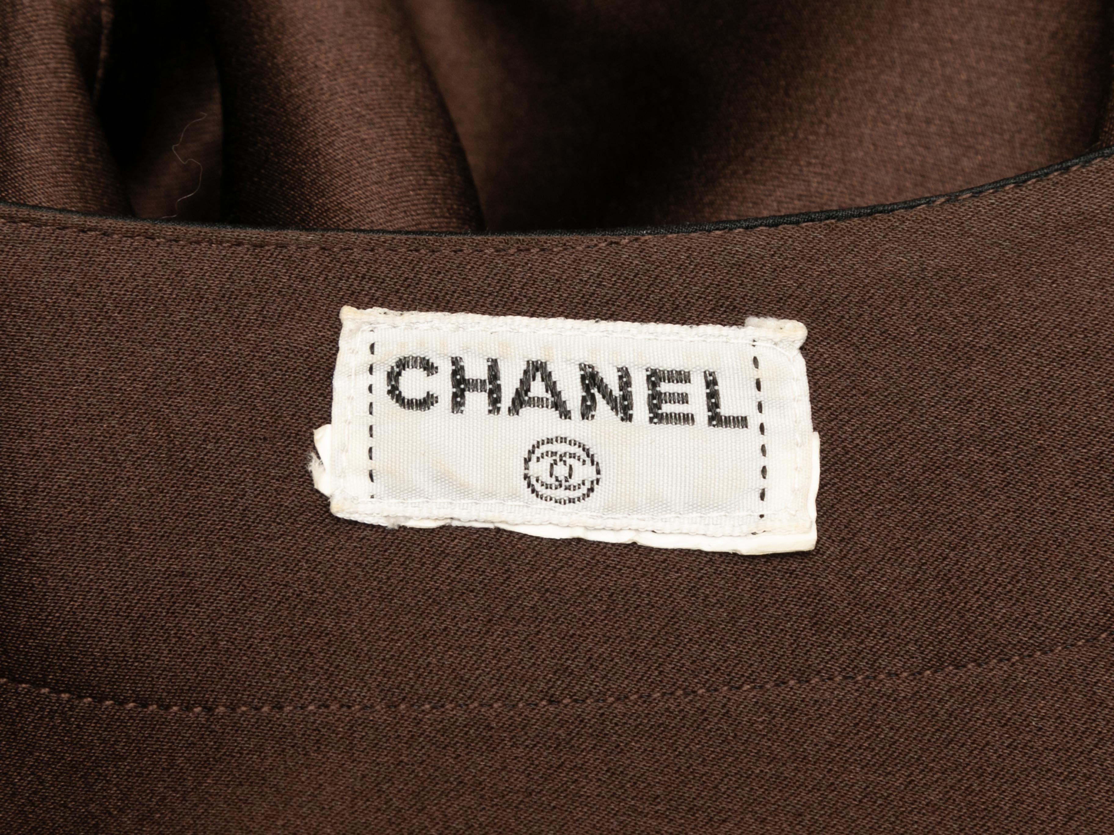 Vintage brown and black silk blouse by Chanel. Crew neck. Long sleeves. Dual bust pockets. Concealed front button closures. 42