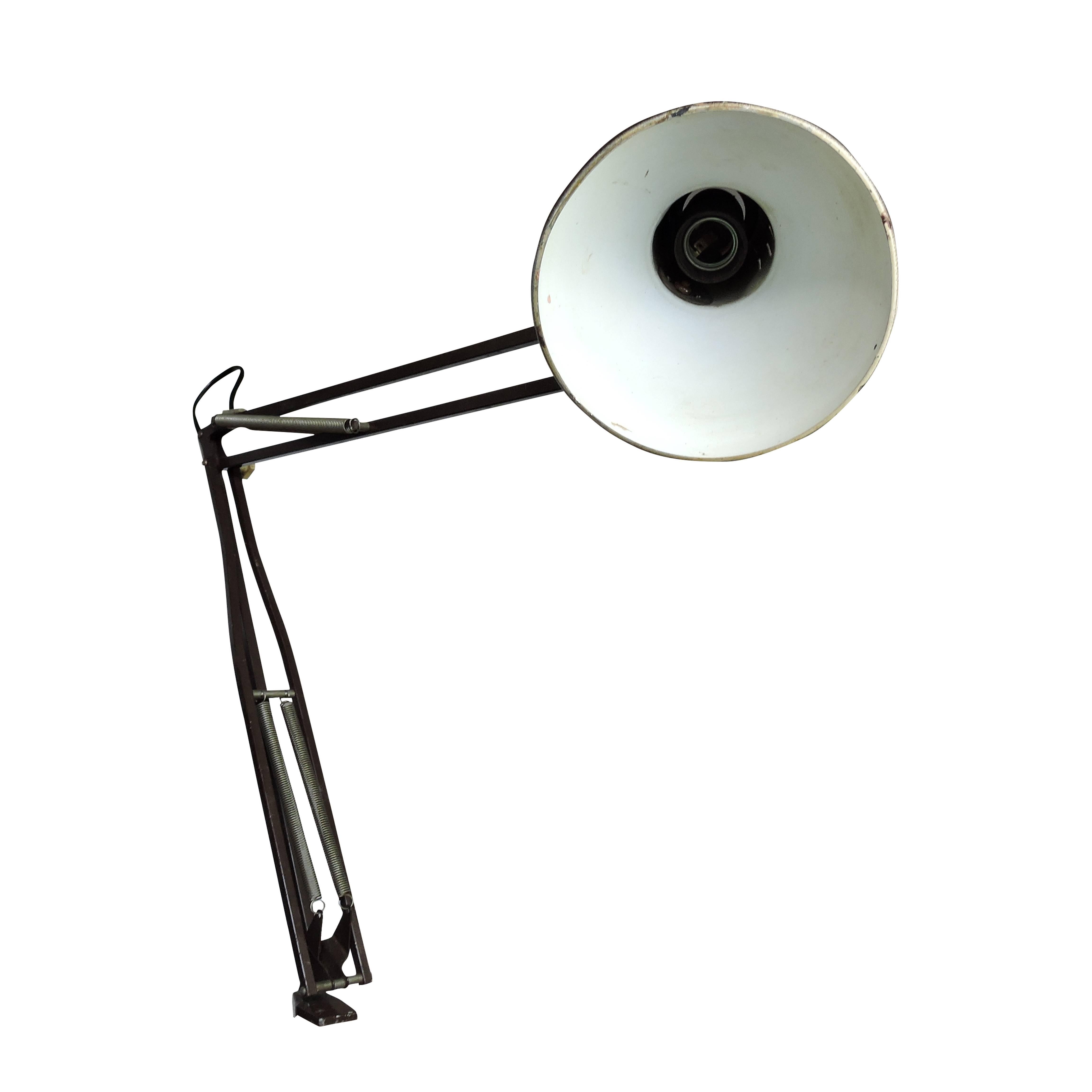 This brown desk lamp from 1960s can be fixed to a desk or shelf using a vice.