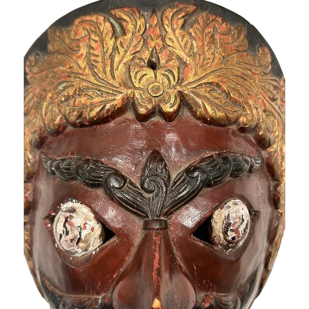 This vintage brown/gold Bali Topeng dance mask is a true piece of art, hand carved from wood by Balinese artists. Topeng dance is a dramatic form of Indonesian dance in which one or more mask wearing, ornately costumed performers interpret tradition