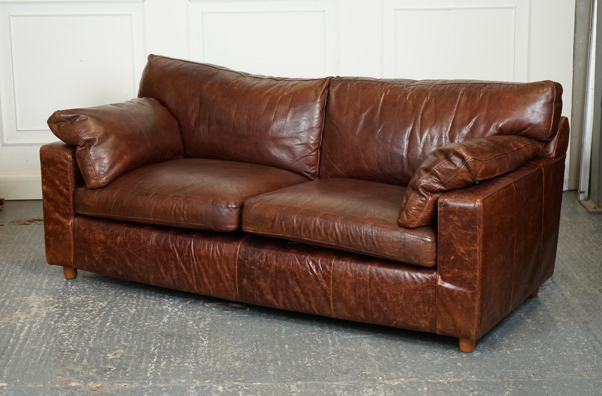 
We are delighted to offer for sale this Vintage Brown Heritage Leather 2 to 3 Seater Sofa is a classic and elegant piece of furniture that exudes timeless charm and sophistication. Crafted from high-quality brown leather with a vintage finish, this