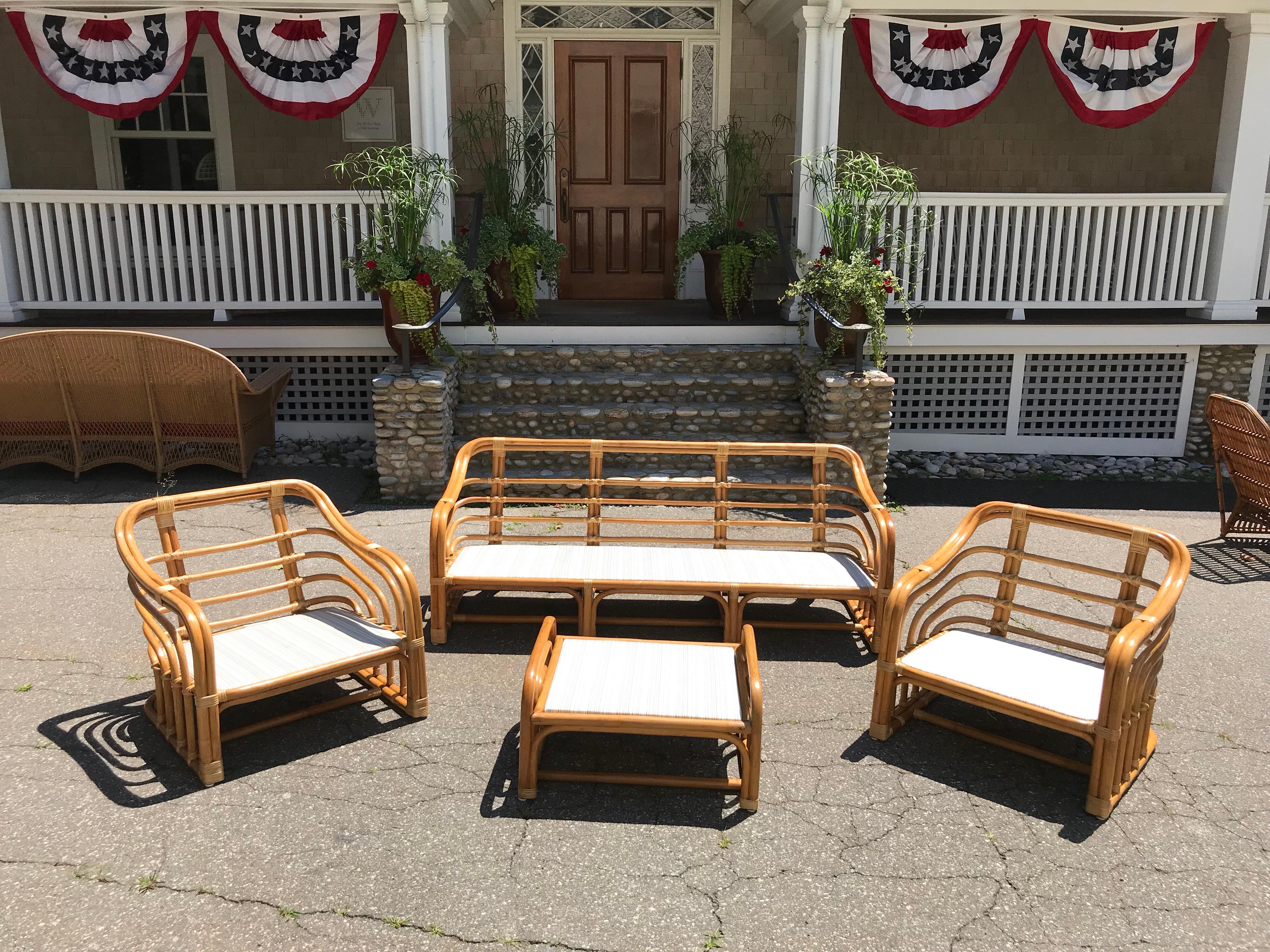 Vintage brown Jordan rattan porch set. Set consists of one sofa, two chairs and one ottoman. Sofa measures 74