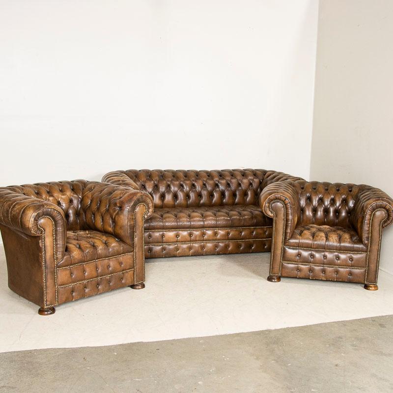 To find an original vintage leather Chesterfield sofa in good condition today is a great find on its own, but to get the complete set with pair of club chairs included makes this a tremendous find that does not come along often. The brown vintage
