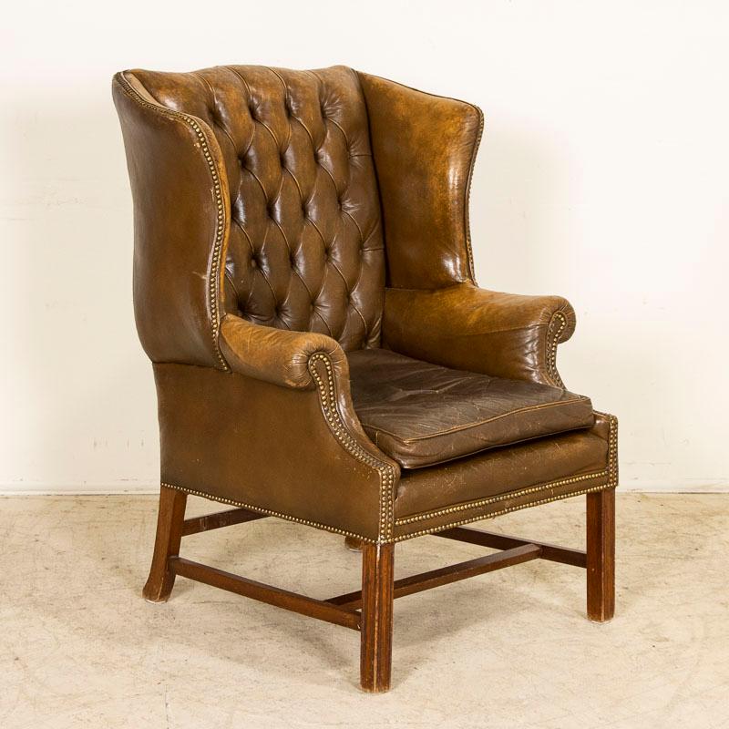 The 1940's era still lingers here and this handsome wingback chair invites one to sit back and relax. This vintage arm chair is in well-kept original condition and sits comfortably, snug within the traditional wing sides. Take a close look at photos