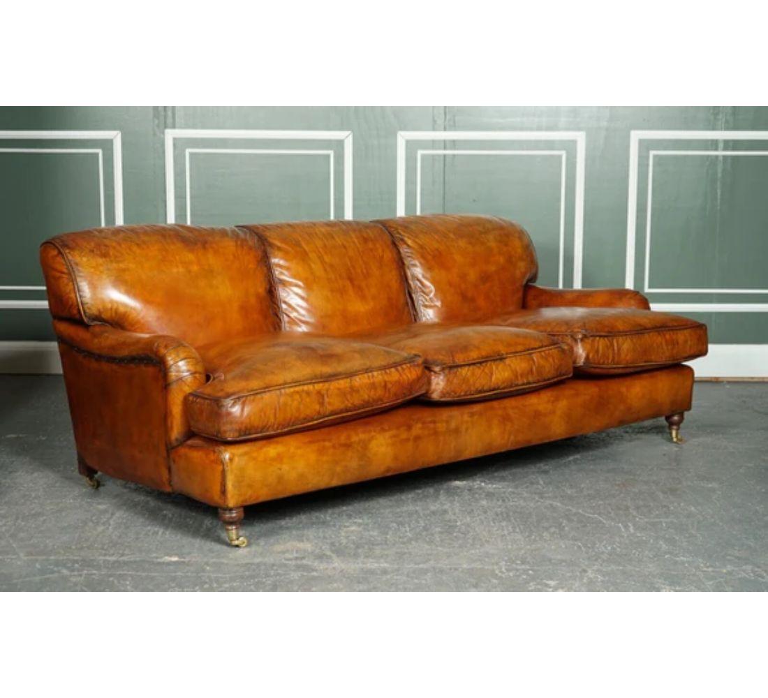 We are delighted to offer for sale this Gorgeous vintage brown leather hand-dyed Howards & Sons style three seater sofa.

Very good looking and timeless model sofa. The back cushions are sewn onto the couch and are filled with goose feathers. The