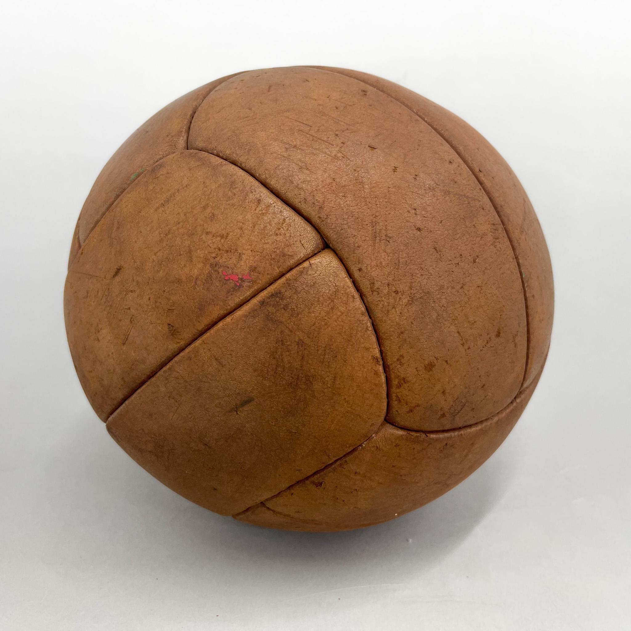 Original vintage heavy leather training ball with beautiful patina. The ball is made of hand-stitched genuine leather in former Czechoslovakia in the 1930's. It can be used as an original interior accessory or as a stylish training aid. The leather