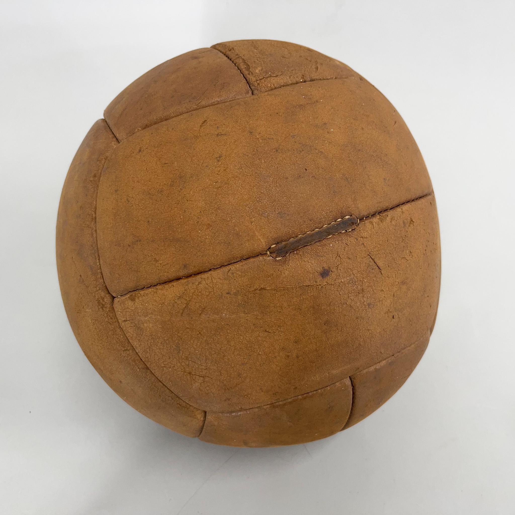Original vintage heavy leather training ball with beautiful patina. The ball is made of handstitched genuine leather in former Czechoslovakia in the 1930s. It can be used as an original interior accessory or as a stylish training aid. The leather
