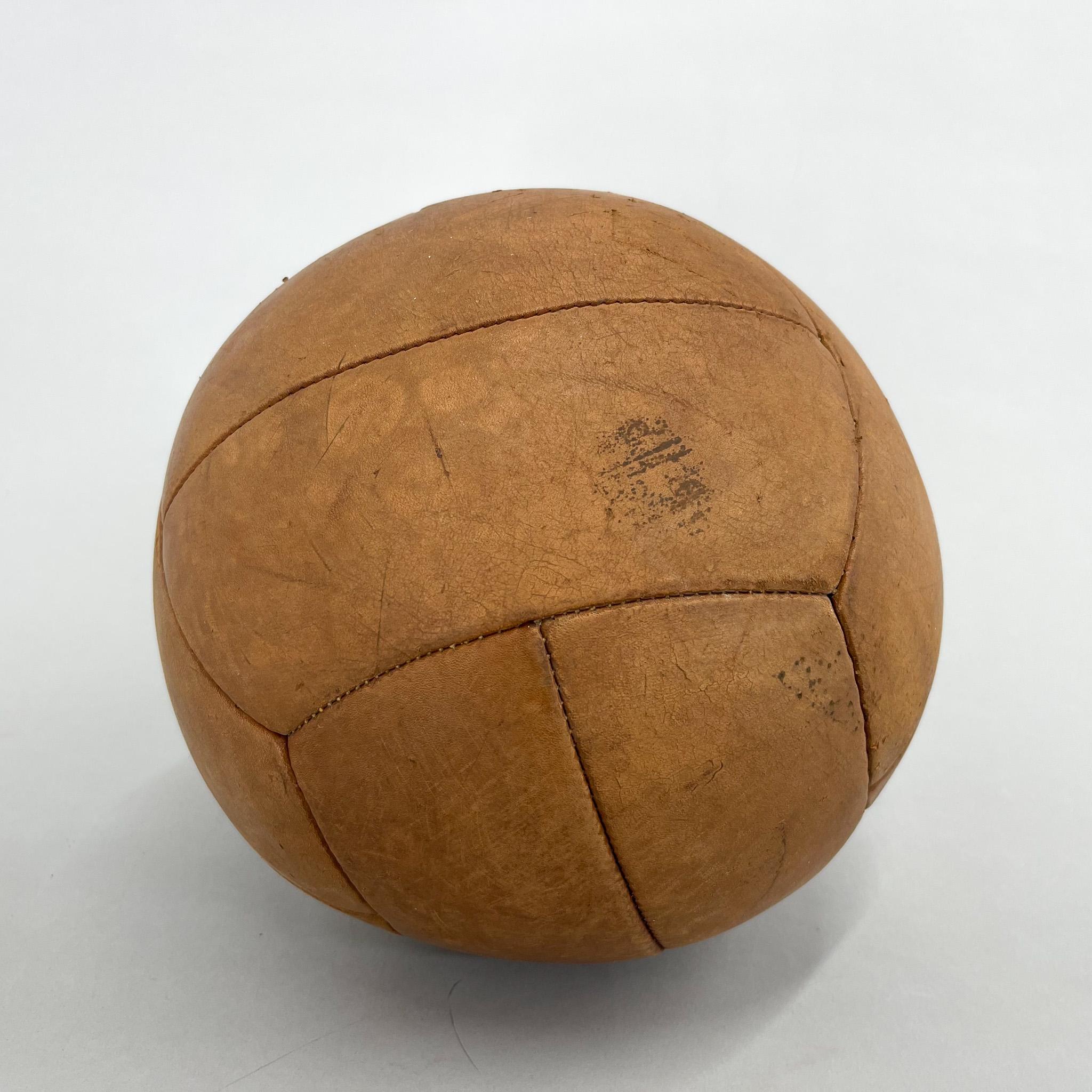 Original vintage heavy leather training ball with beautiful patina. The ball is made of handstitched genuine leather in former Czechoslovakia in the 1930s. It can be used as an original interior accessory or as a stylish training aid. The leather