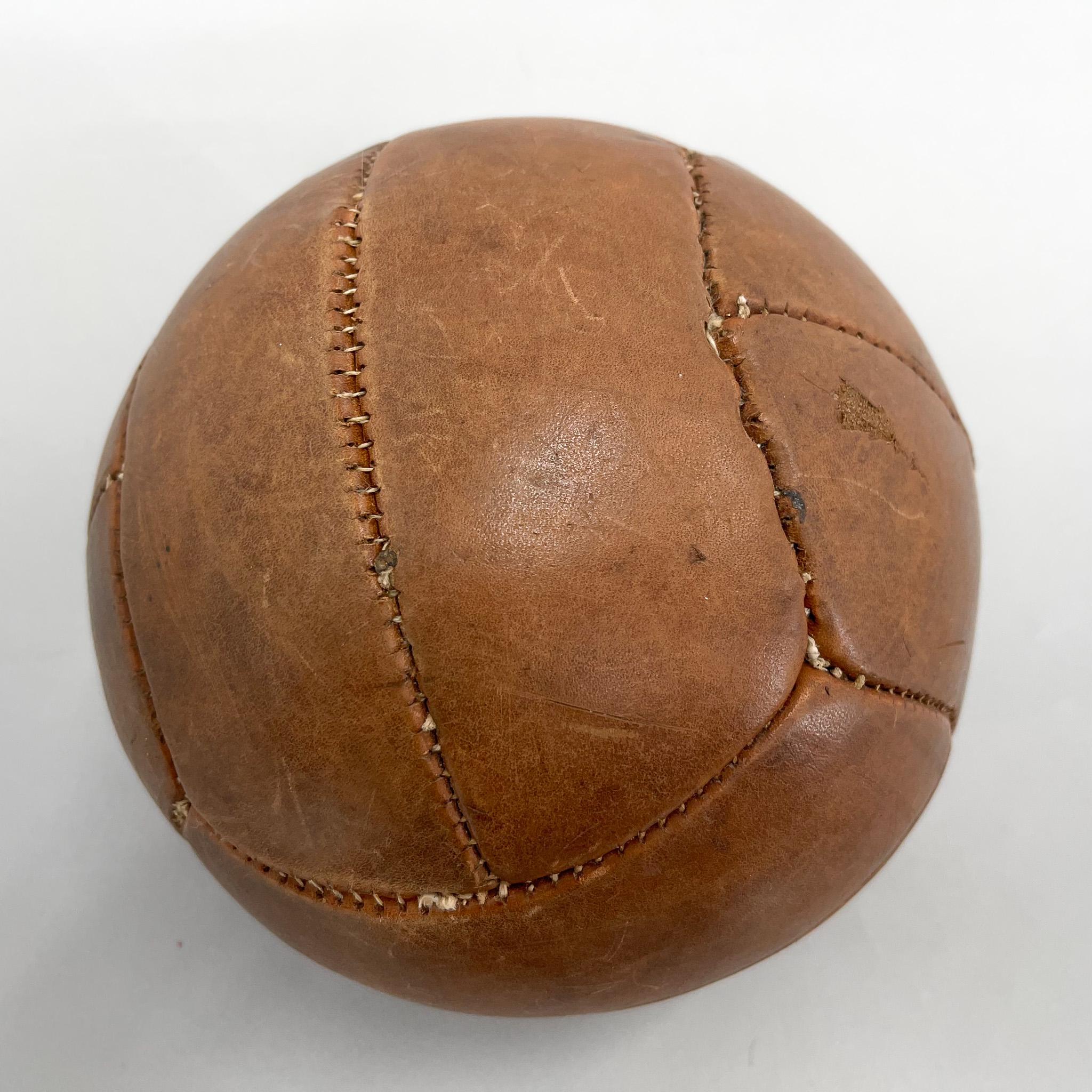 Original vintage heavy leather training ball with beautiful patina. The ball is made of handstitched genuine leather in former Czechoslovakia in the 1930s. It can be used as an original interior accessory or as a stylish training aid. The leather