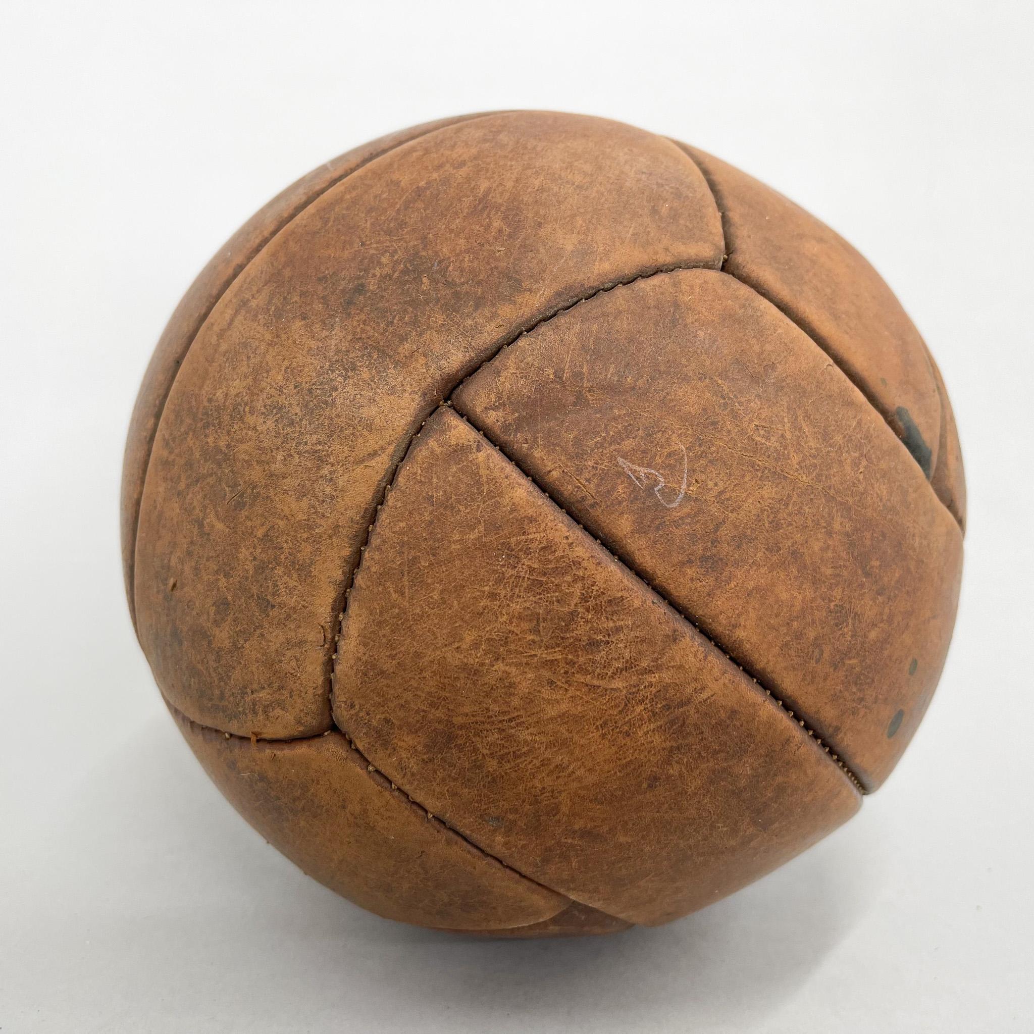 Original vintage heavy leather training ball with beautiful patina. The ball is made of handstitched genuine leather in former Czechoslovakia in the 1930s. It can be used as an original interior accessory or as a stylish training aid. The leather