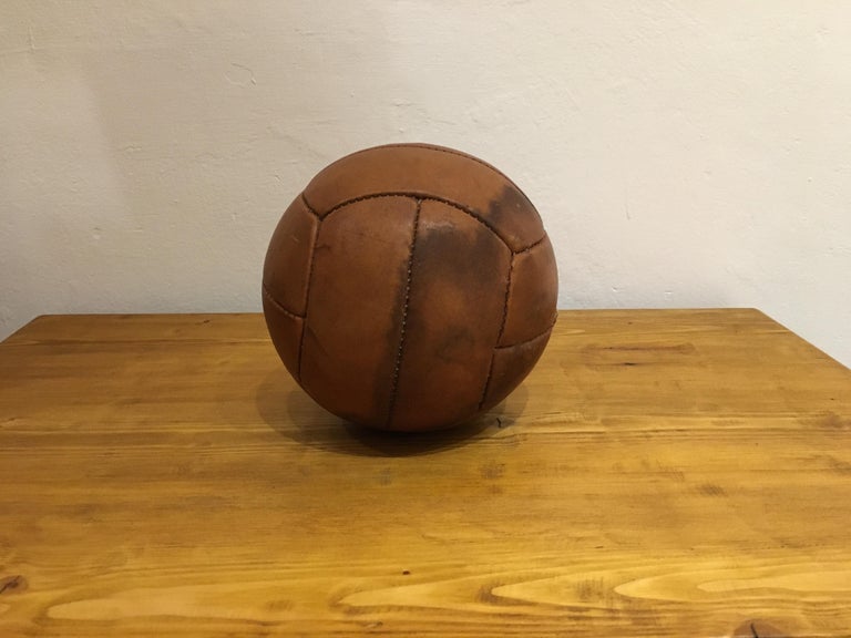 This medicine ball comes from the stock of an old Czech gymnasium. Made in the 1930s. Patina consistent with age and use. Cleaned and treated with a special leather care. Measures: Weight 1kg. Diameter 7, 5 inch.