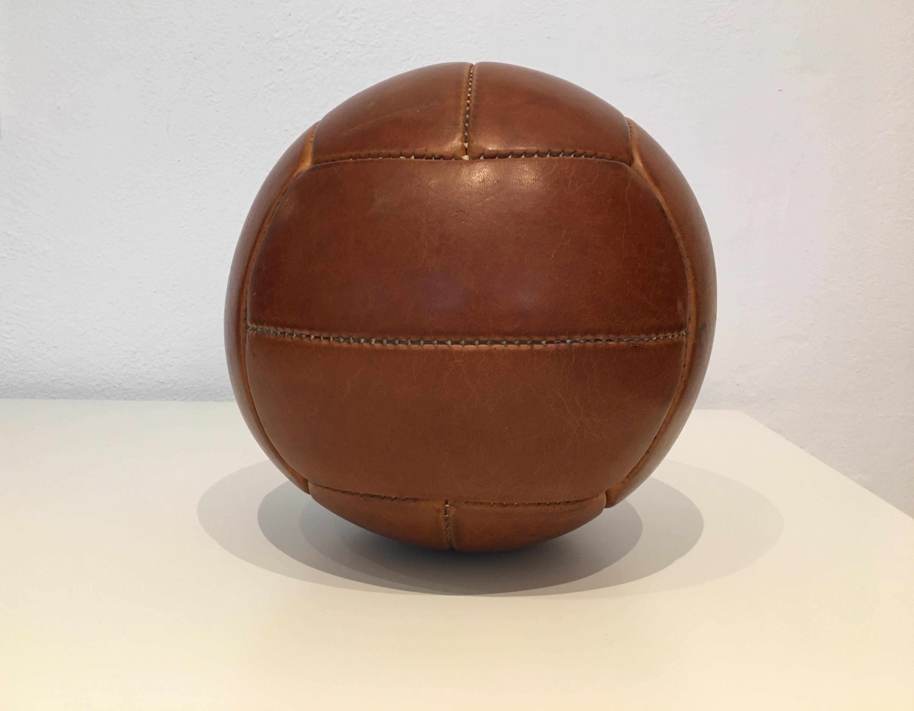 This medicine ball comes from the stock of an old Czech gymnasium. Made in the 1930s. Patina consistent with age and use. Cleaned and treated with a special leather care. Weight: 2kg. Measures: Diameter 9.4 inch.