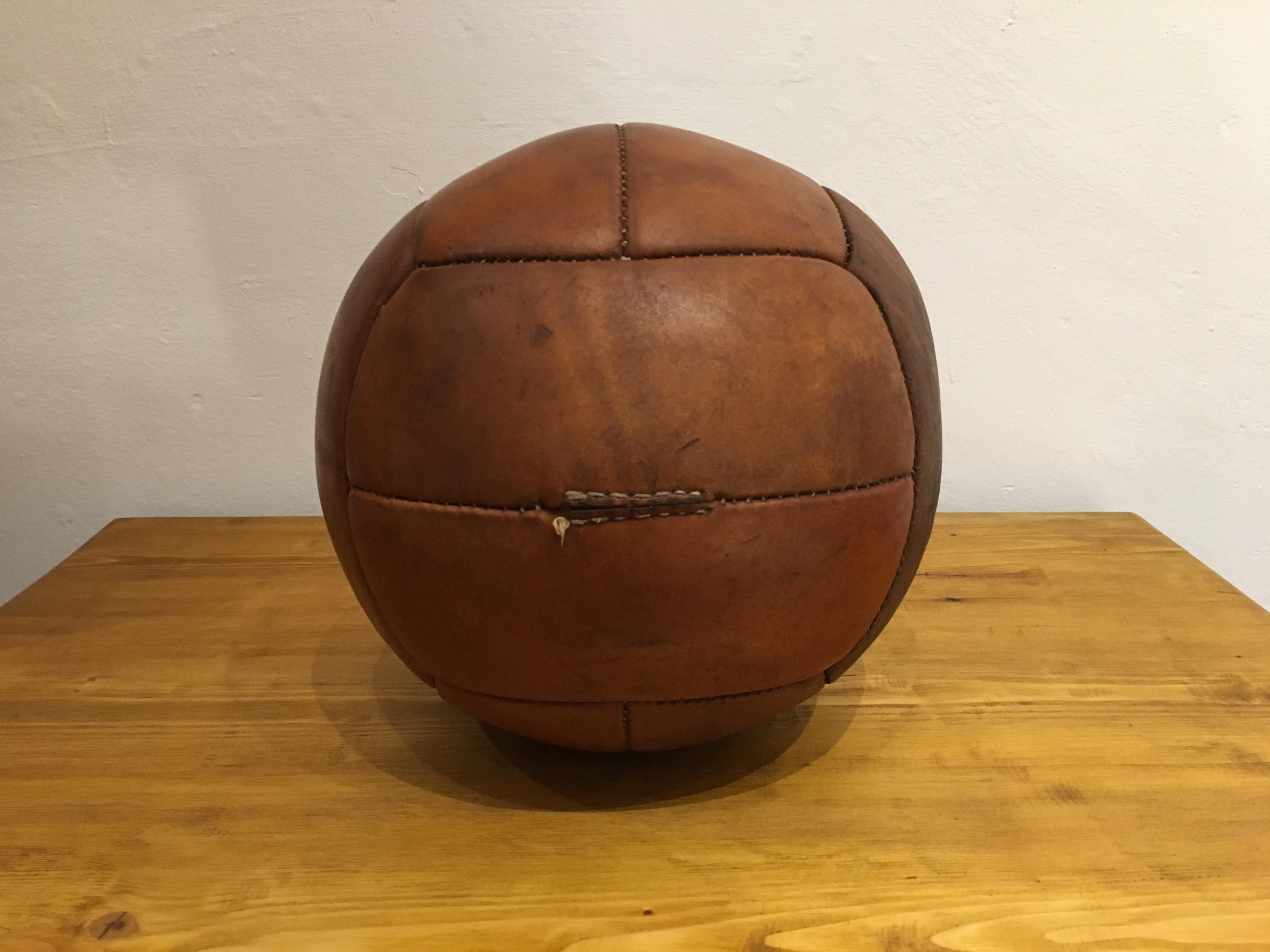 This medicine ball comes from the stock of an old Czech gymnasium. Made in the 1930s. Patina consistent with age and use. Cleaned and treated with a special leather care. Weight: 3kg. Measures: Diameter 10.2 inch.
 