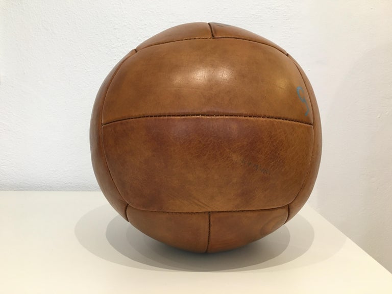 This medicine ball comes from the stock of an old Czech gymnasium. Made in the 1930s. Patina consistent with age and use. Cleaned and treated with a special leather care. Weight: 5kg. Measures: 12,99 inch.