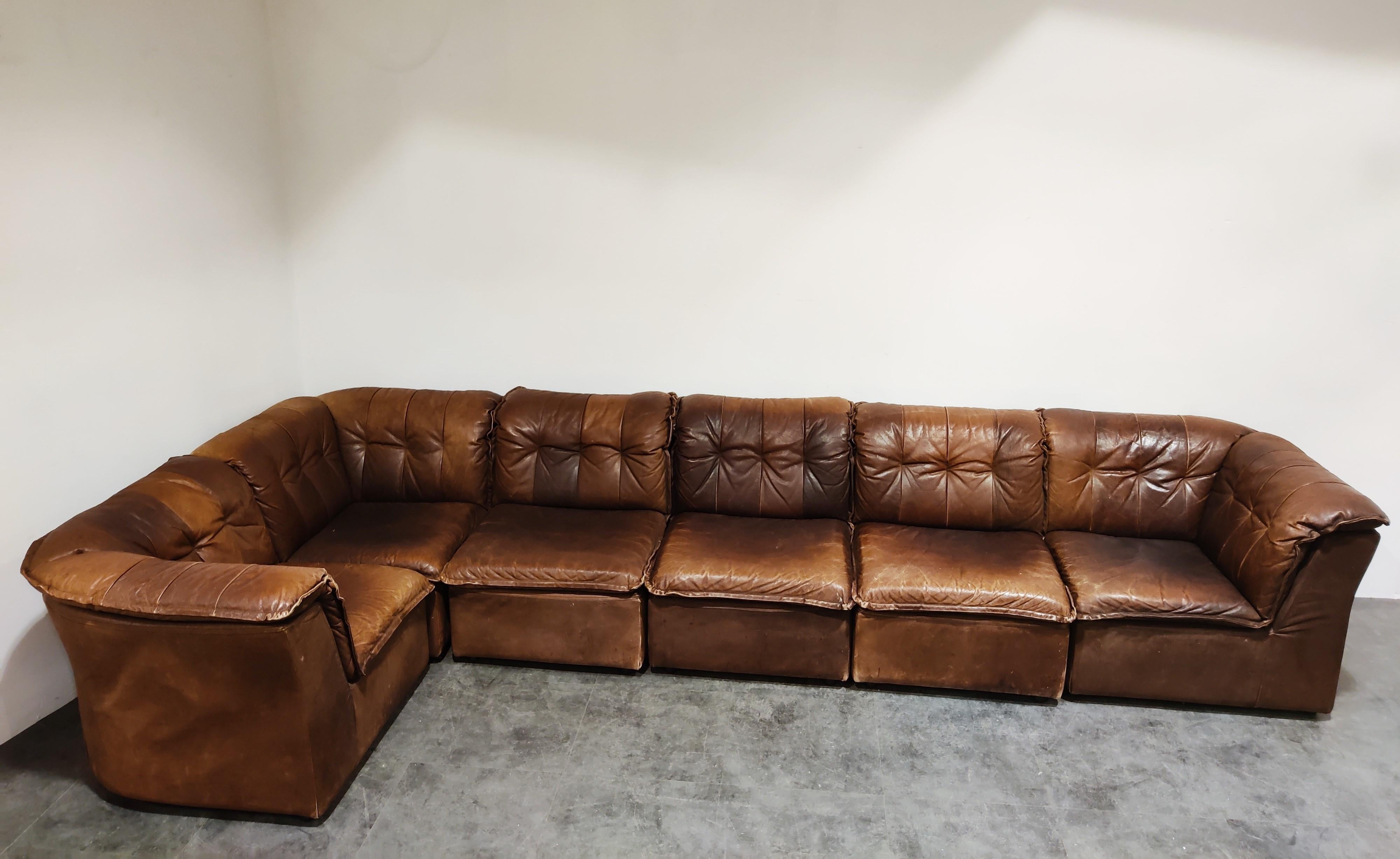 Mid century sectional/modular sofa set in beautifully patinated dark brown leather.

The sofa set is completely modular and consists of 6 elements.

Ideal piece to create a free standing sofa space which will be the center piece of your living