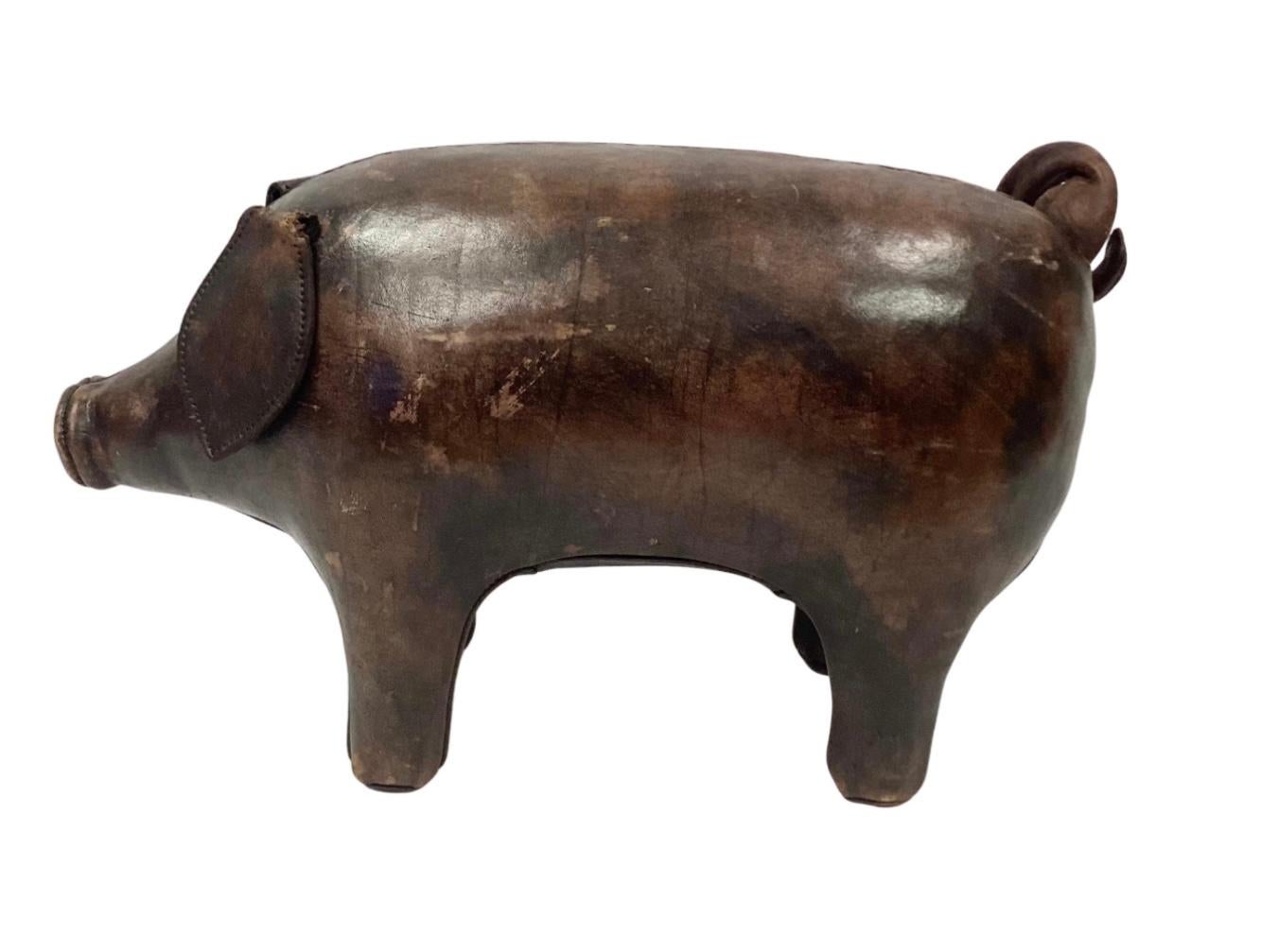 Vintage brown leather upholstered pig crafted by Omersa & Co. (Lincolnshire, UK), probably for Abercrombie & Fitch, with rolled leather eyes, snout, and metal capped feet. Wonderful rich patina.