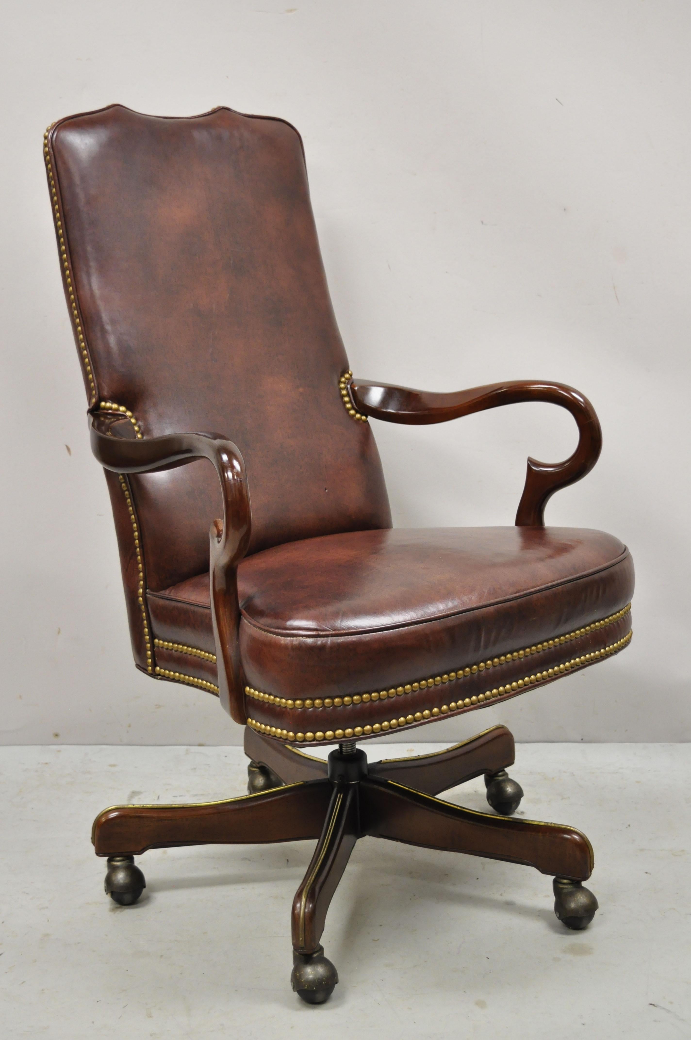 Vintage Brown Leather Queen Anne rolling executive office desk arm chair. Item features adjustable height, tilt spring back, wooden base, brown leather upholstery, solid wood frame, beautiful wood grain, very nice item, quality American