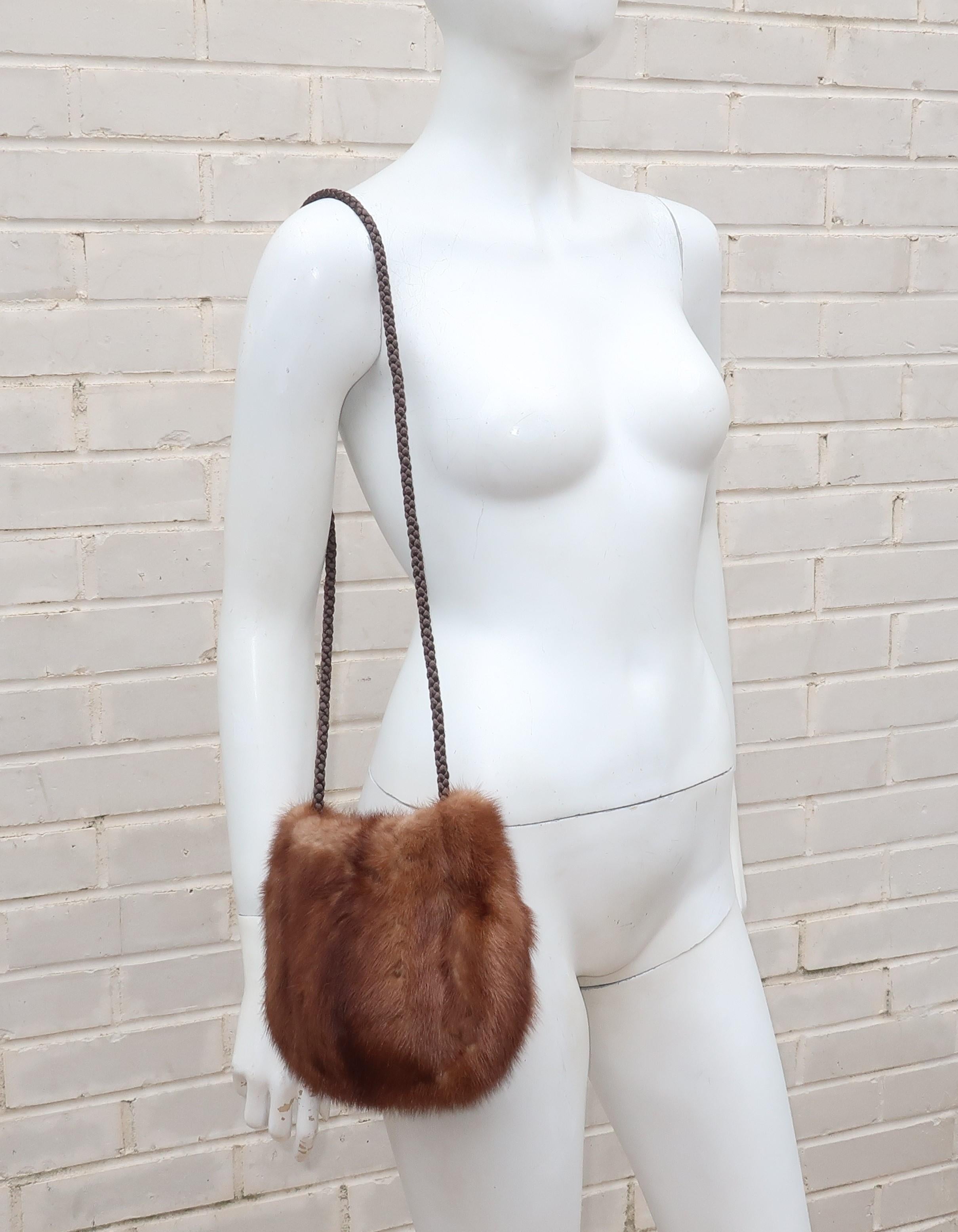 From one generation to the next!  This sumptuous brown mink handbag with a braided silk cord shoulder strap, snap closure and silk jacquard lining was repurposed by an Atlanta furrier C.1990 from a classic 1950's stole.  It would be perfect paired