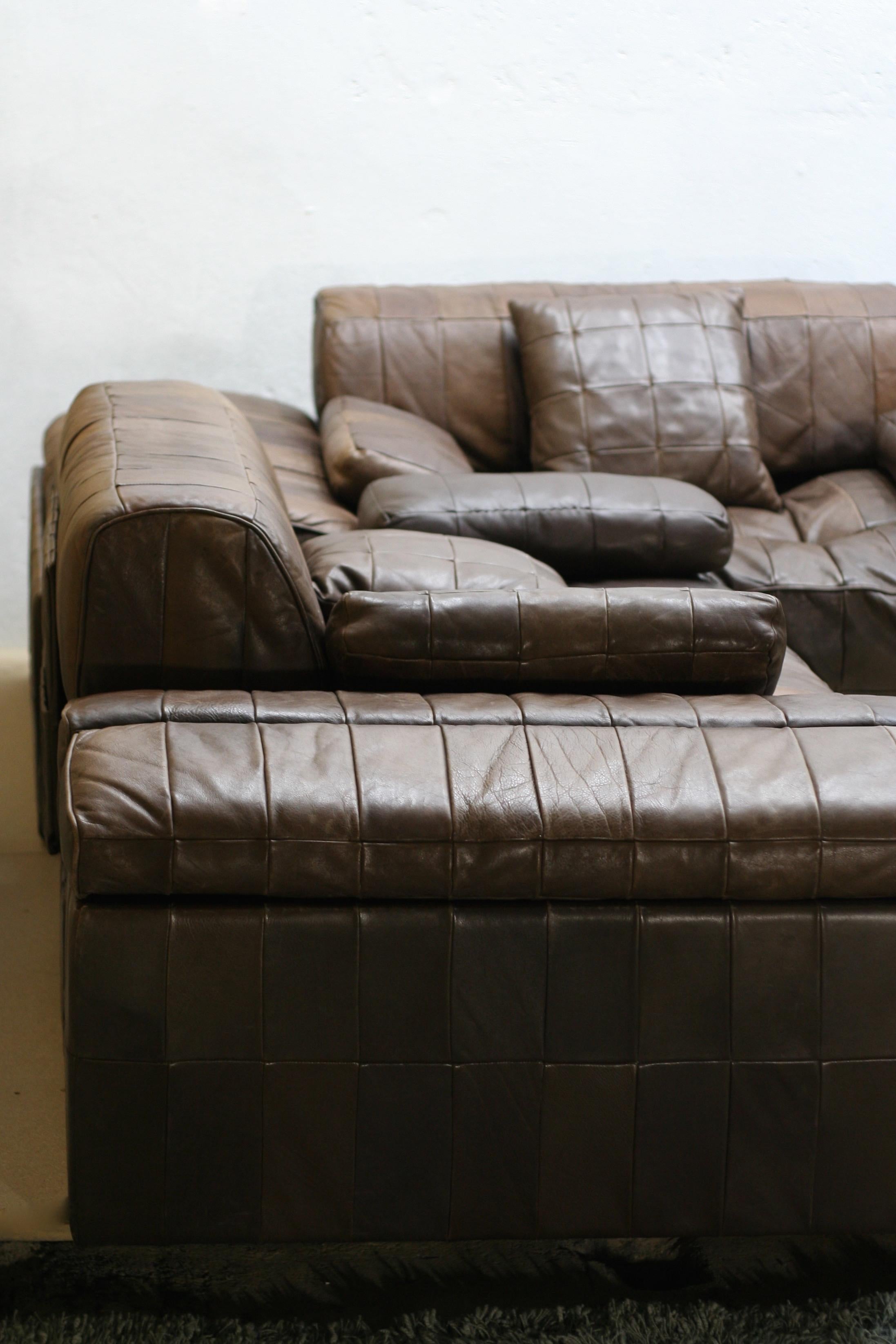 4 modules H 65 cm, H(seat) 40 cm, W 90 cm, D 90 cm. Each module consists of a square mat on a leather covered wooden base with back and a magazine pocket on it.

2 storage pieces with upper cushions (can be converted to side tables with white