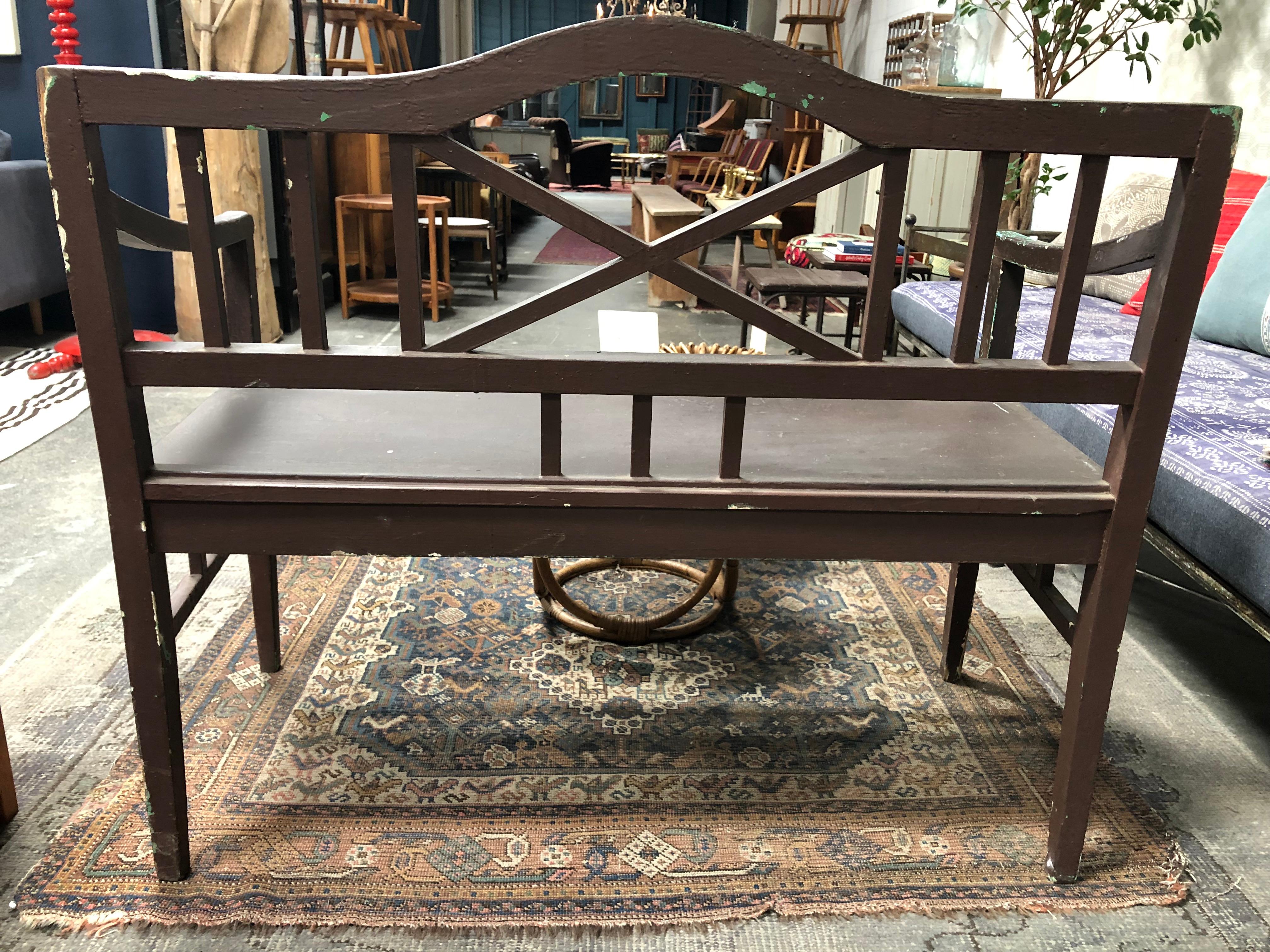 Float away to a secret garden in our midcentury wooden garden bench. Sturdily built in a delicious and rustic brown paint, brighten this piece with outdoor pillows or a long seat cushion for lounging.

Measures: Seat height 19.5