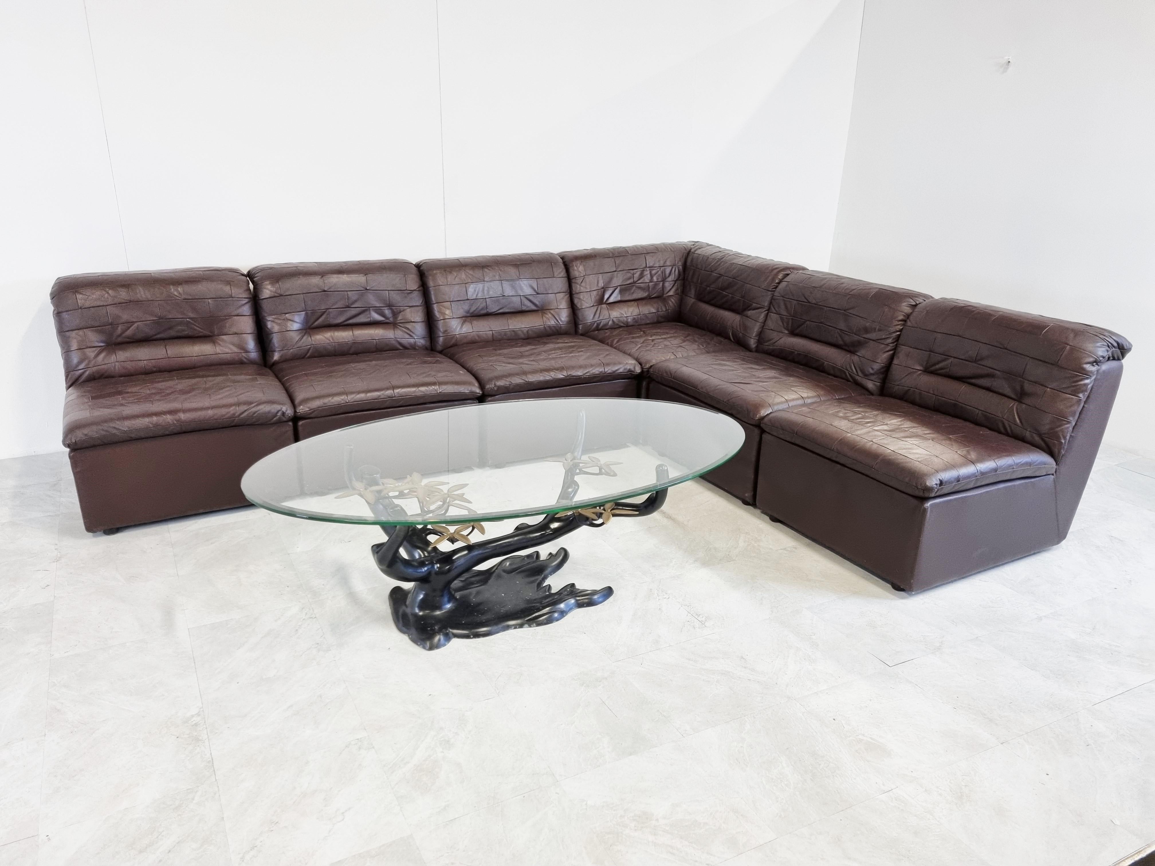 Mid century sectional/modular sofa set in beautifully patchwork chocolate brown leather.

The sofa set is completely modular and consists of 7 elements.

Ideal piece to create a free standing sofa space which will be the center piece of your