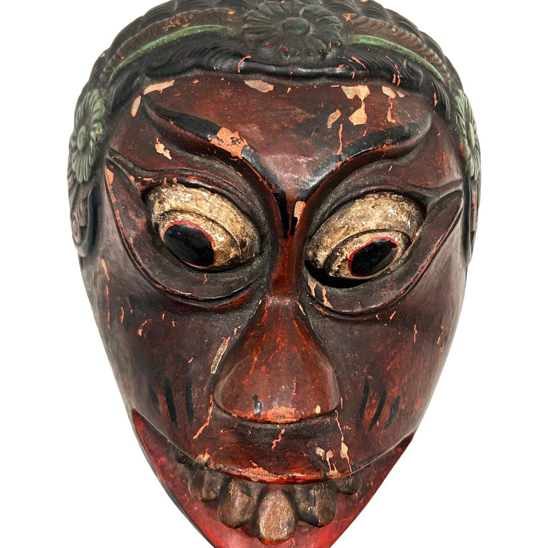 This vintage brown/red Bali Topeng dance mask is a true piece of art, hand carved from wood by Balinese artists. Topeng dance is a dramatic form of Indonesian dance in which one or more mask wearing, ornately costumed performers interpret tradition