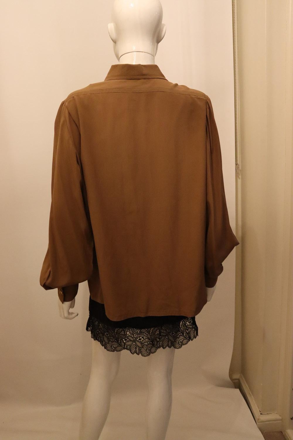 A lovely , stylish vintage silk blouse in milk chocolate colour brown silk. The blouse has a button front opening, two breast pocket and single button cuffs, with all the original buttons.
Measurements: Bust up to 46'', length 30''