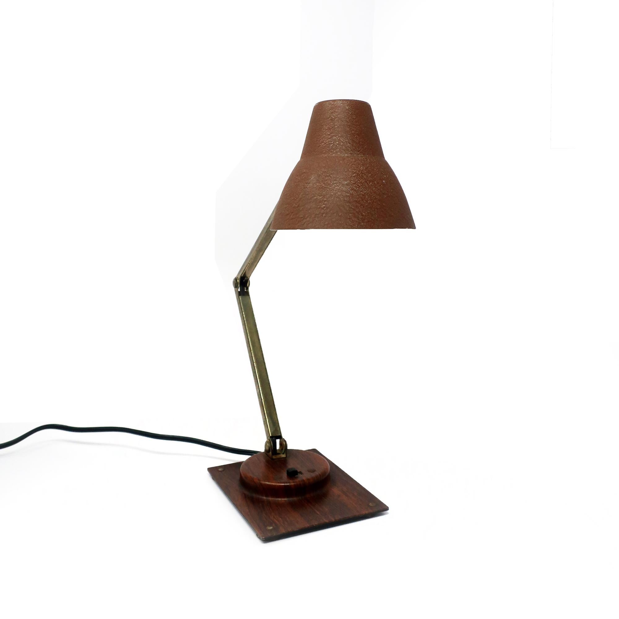 A perfect mid-century modern Tensor articulating desk lamp. Brown wood grain base and brown textured shade, chrome stem, and switch on the base. In very good vintage condition.

4” x 8.5” x 14”, extends to 20” tall