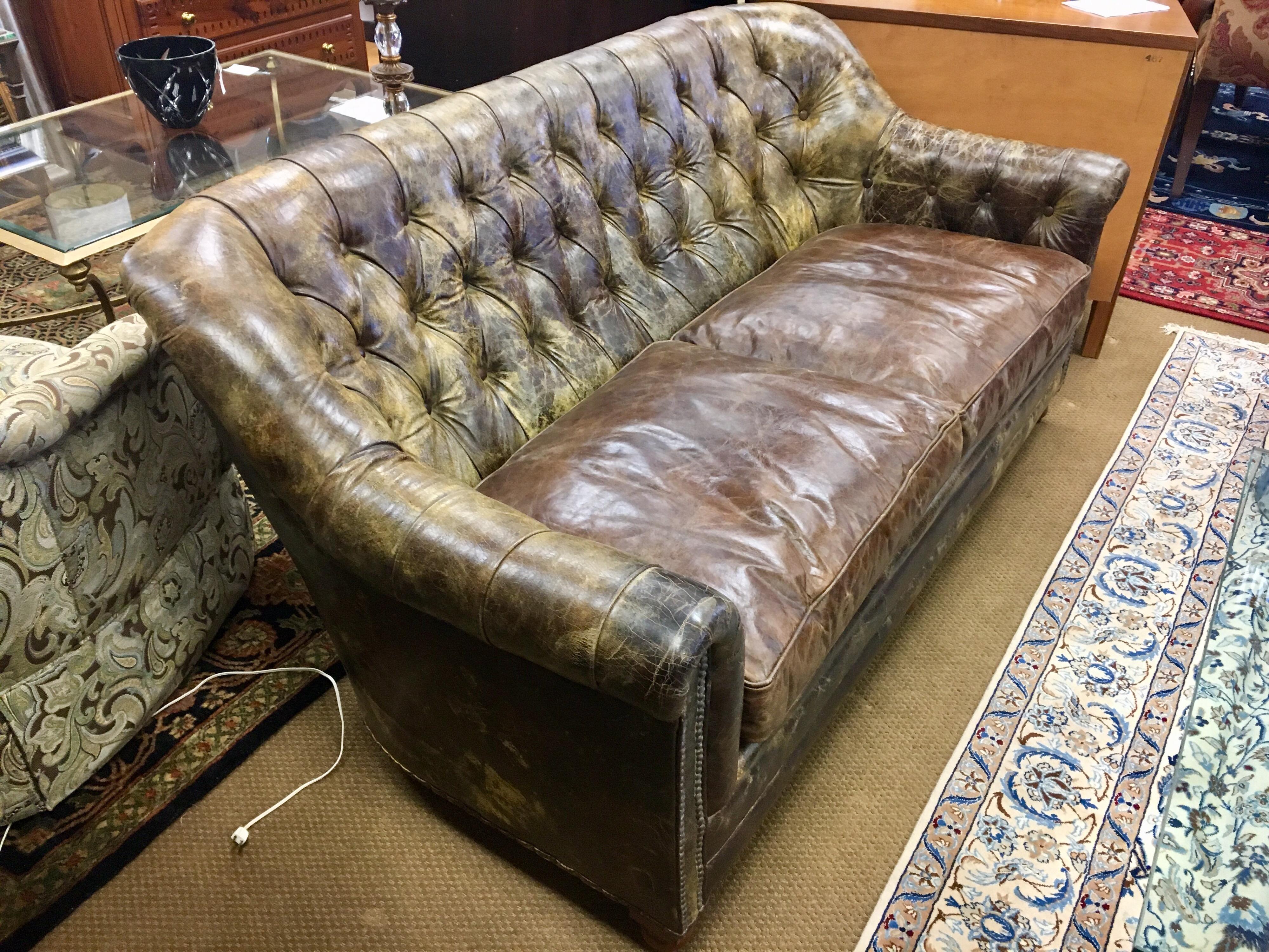 Great looking distressed, on purpose, all leather six foot sofa. The perfect scale for that apartment or house. Tufting on back, nailheads throughout and caster wheels for ease of movement. The leather is soft and of the highest quality and the