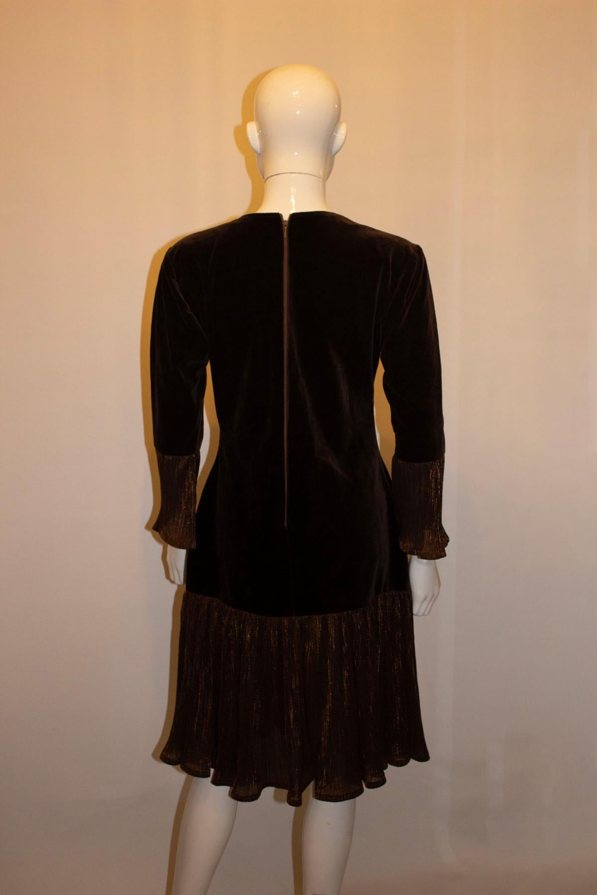 A fun vintage party dress in an attractive brown velvet. The dress has a drop waist, and frill detail on the cuffs and hem.  It is unlined. 
Measurements: Bust 38'', length 41''