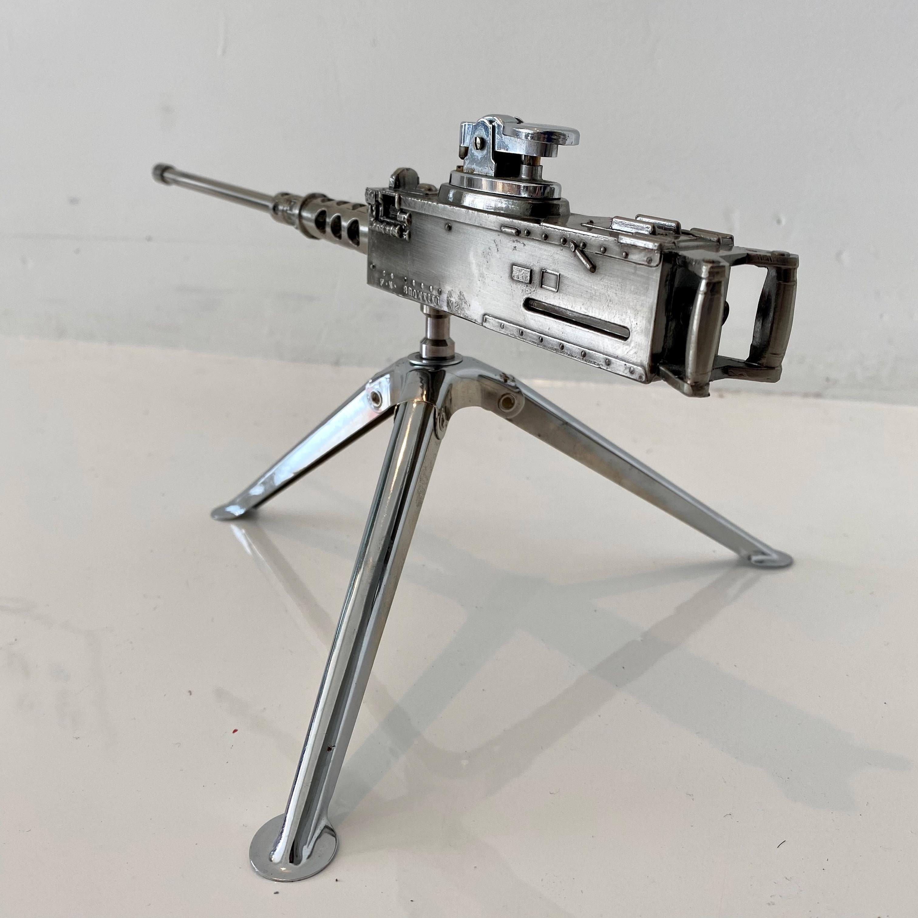 Cool vintage table lighter in the shape of a Browning M2 machine gun. Made of metal and rotates 360 degrees. Tripod arms fold up and down. Made in Japan. Cool tobacco accessory and conversation piece. Working lighter. Great vintage condition.