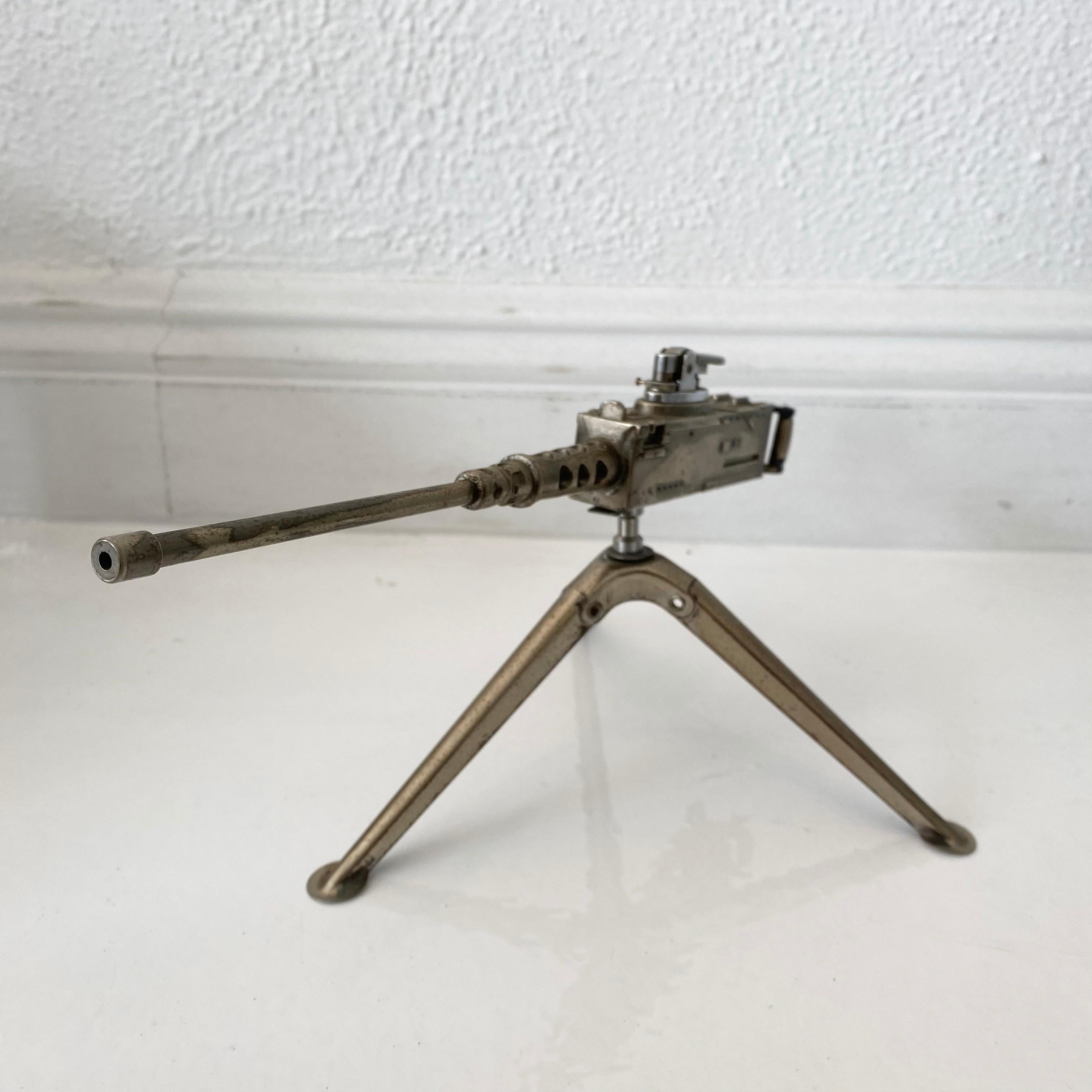 Cool vintage table lighter in the shape of a Browning M2 machine gun. Made of metal and rotates 360 degrees. Tripod arms fold up and down. Made in Japan. Cool tobacco accessory and conversation piece. Working lighter. Good vintage condition. Small