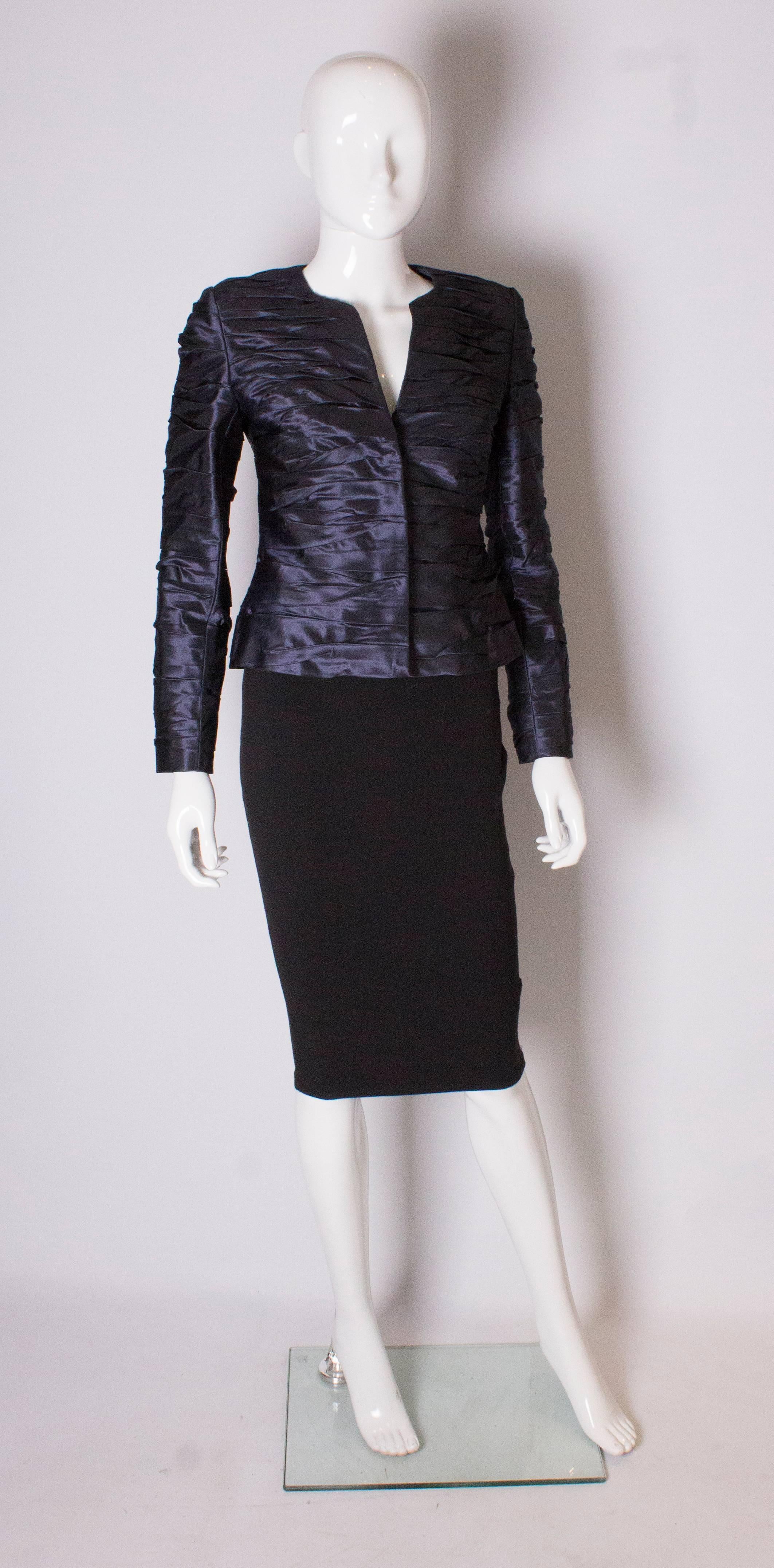 A great couture jacket by Bruce Oldfield. In a blue silk , with a crinkle effect. The jacket has a v neckline, and fastens with a zip and hooks and eyes.