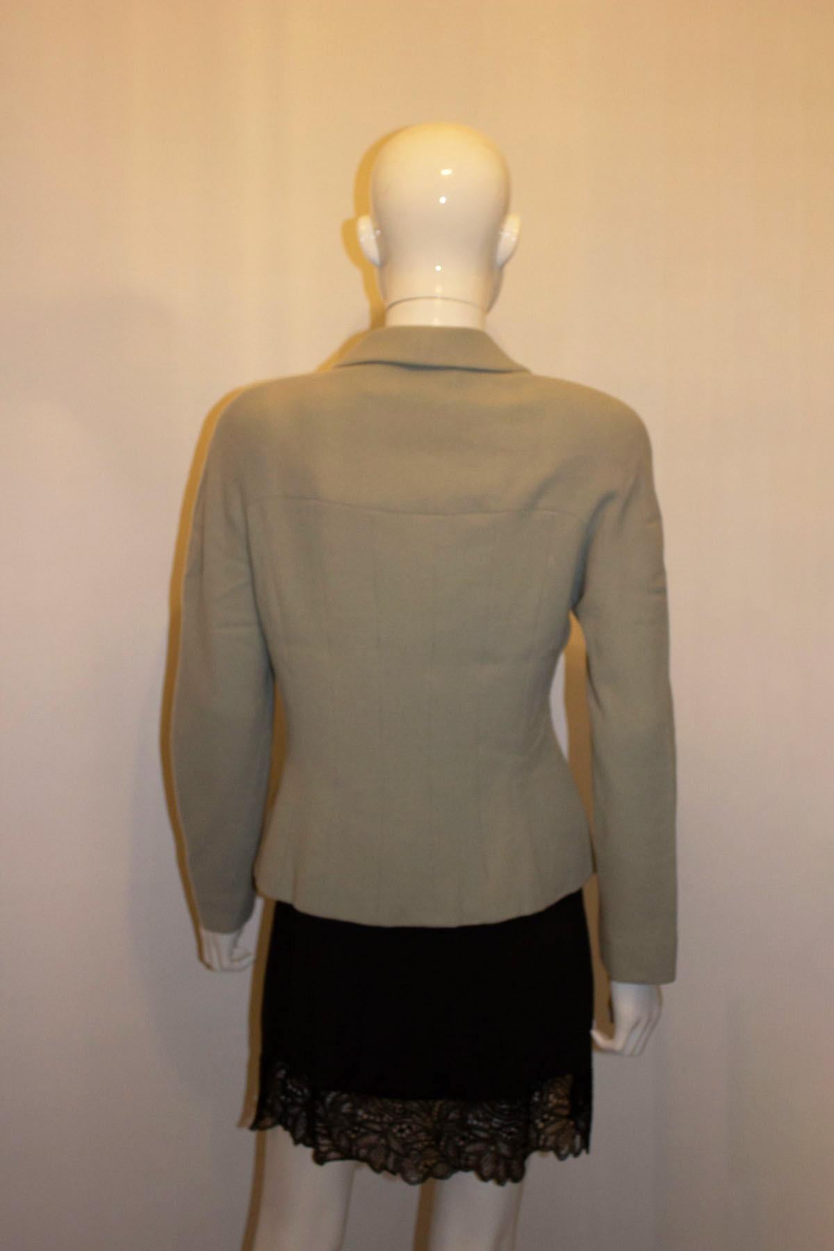 A pretty vintage jacket by British designer, and royal favourite Bruce Oldfield.  In a  light sage green colour, the jacket has shawl collar, and three button front fastening. As you would expect the jacket has great tailoring, and is fully lined.