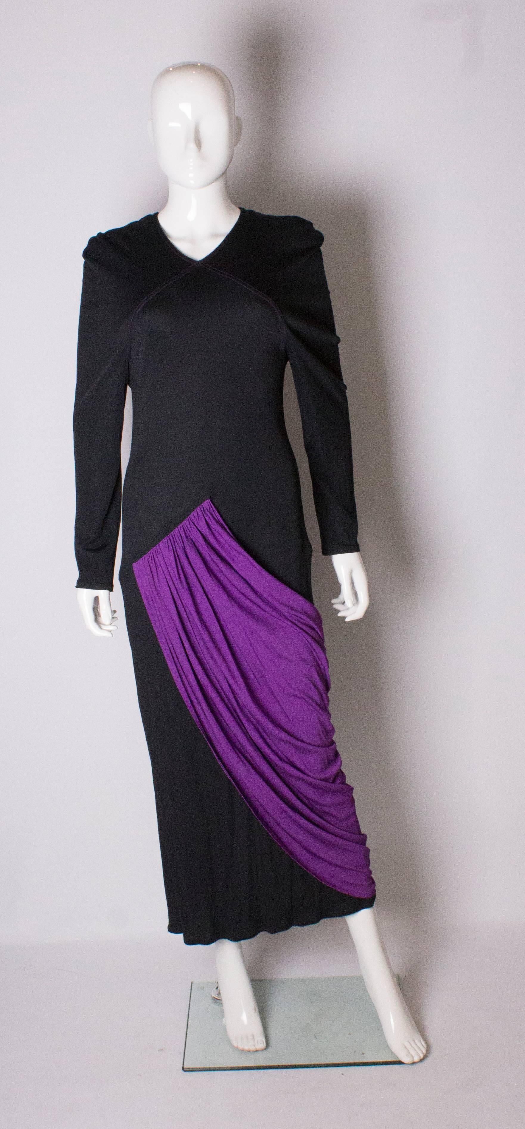  A great vintage  gown in black and purple by Bruce Oldfield. The dress has a v neckline with a purple pleated over skirt.- front and back. The dress has a 14 1/2 