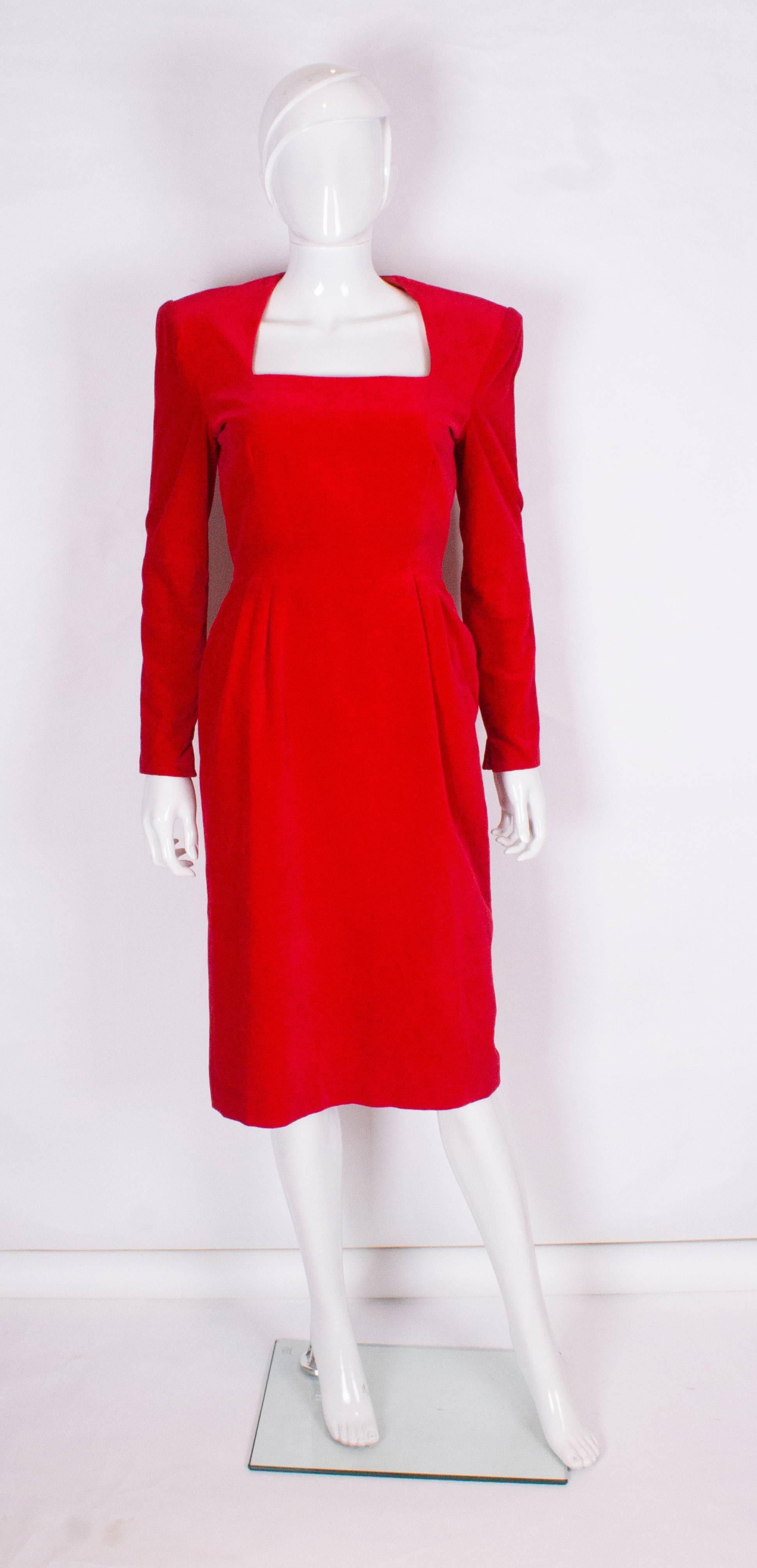 A great vintage  dress for Fall and the festive season by British designer Bruce Oldfield.
In red velvet, the dress has a square neckline, 2'' slits at the sleeves, a back zip and is fully lined.