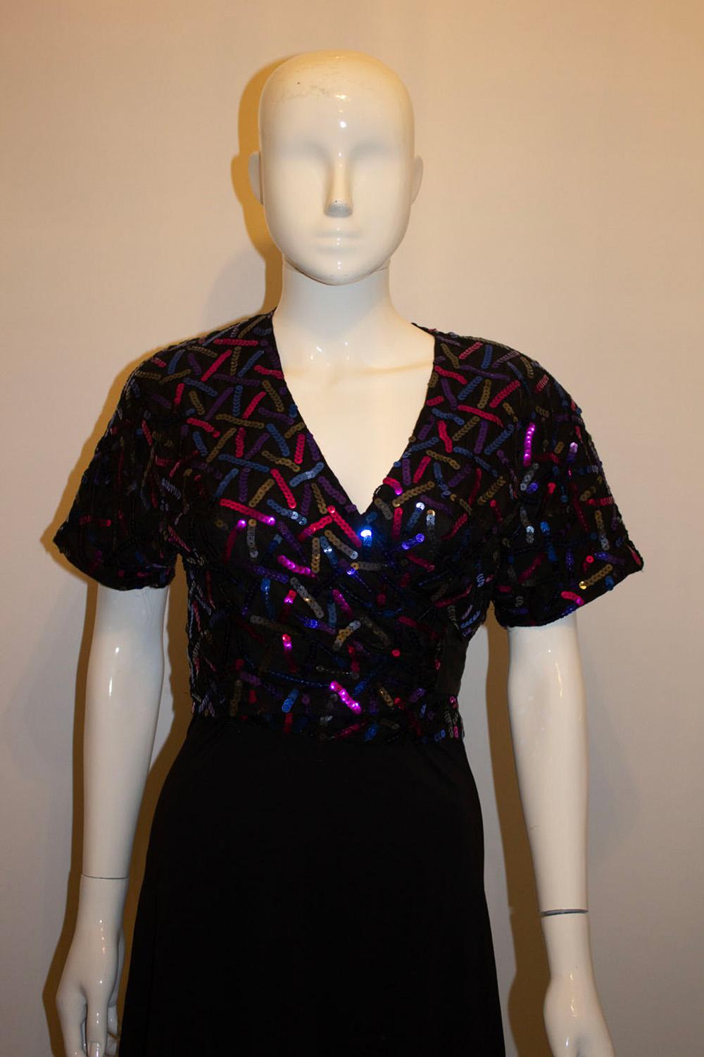 A pretty vintage bolero jacket by Bruce Oldfield ( a favorite of Queen Camilla). The bolero has a black background with sequin decoration in pink and blue. It is fully lined. 
Made in England. UK size 10.
Measurements: Bust up to 39'', length 17''