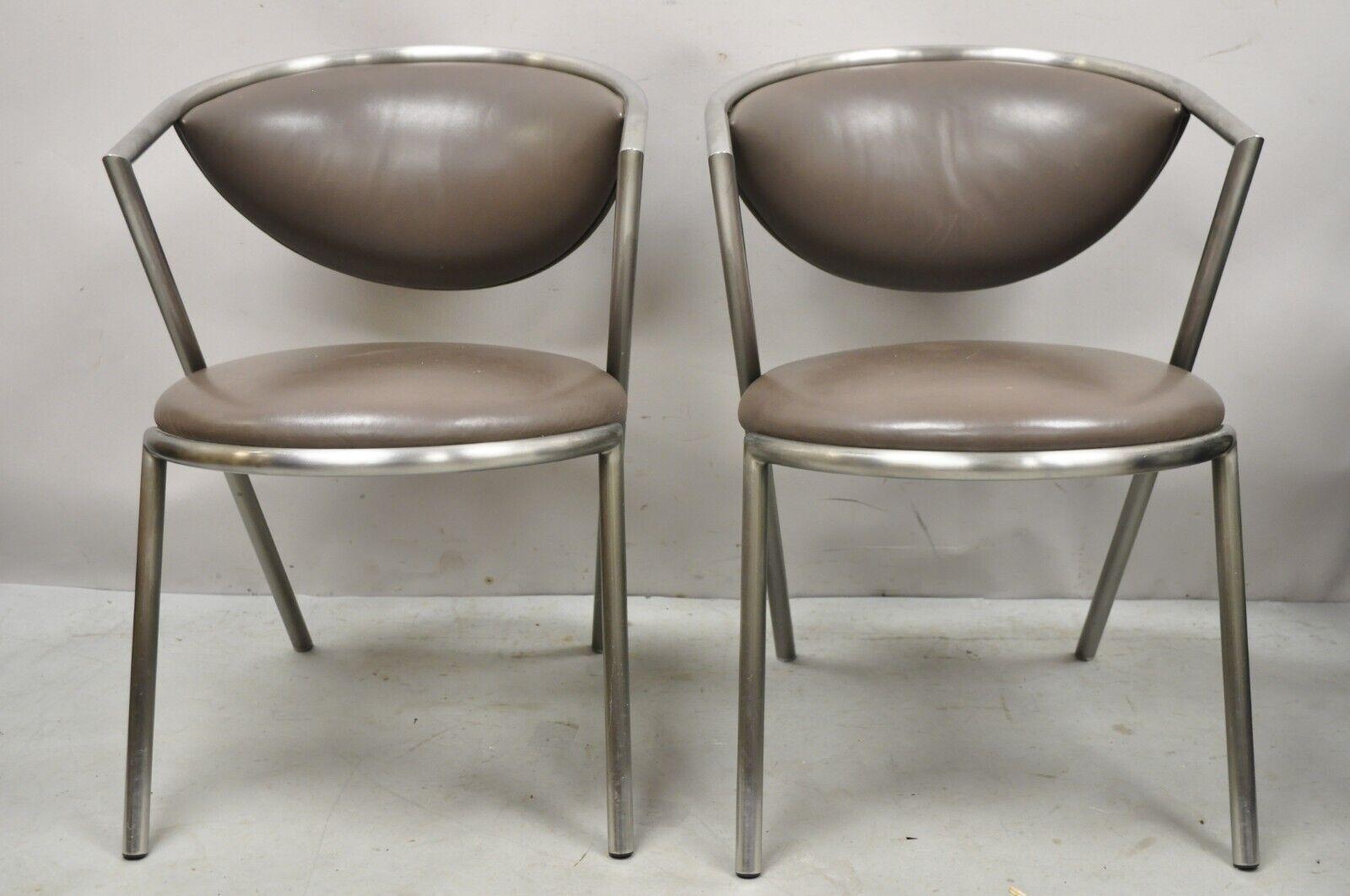 Vintage Brueton Mid-Century Modern tubular steel cat eye chairs - a pair. Item features brushed stainless steel frames, original brown vinyl upholstery, 